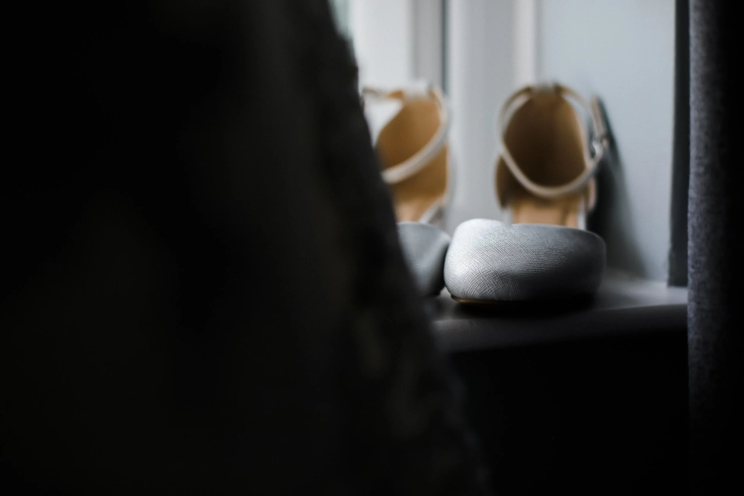 Elegant Details: A Pair of Wedding Shoes Bathed in Soft Natural Light, Adding a Touch of Beauty and Grace to the Bride's Attire.