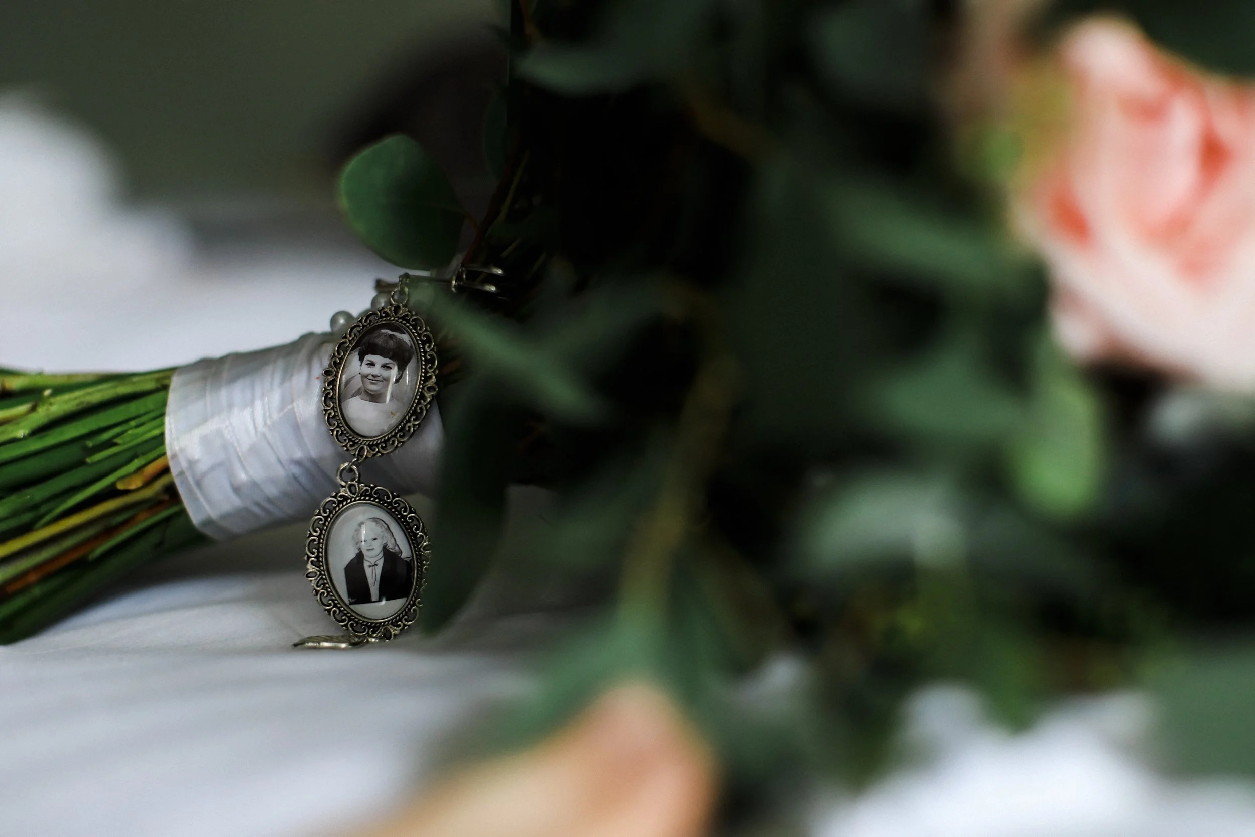 In Loving Memory: A Touching Tribute to a Loved One with a Photo on the Bride's Bouquet, Preserving Their Memory and Presence on a Special Day at Brook Hall Hotel.
