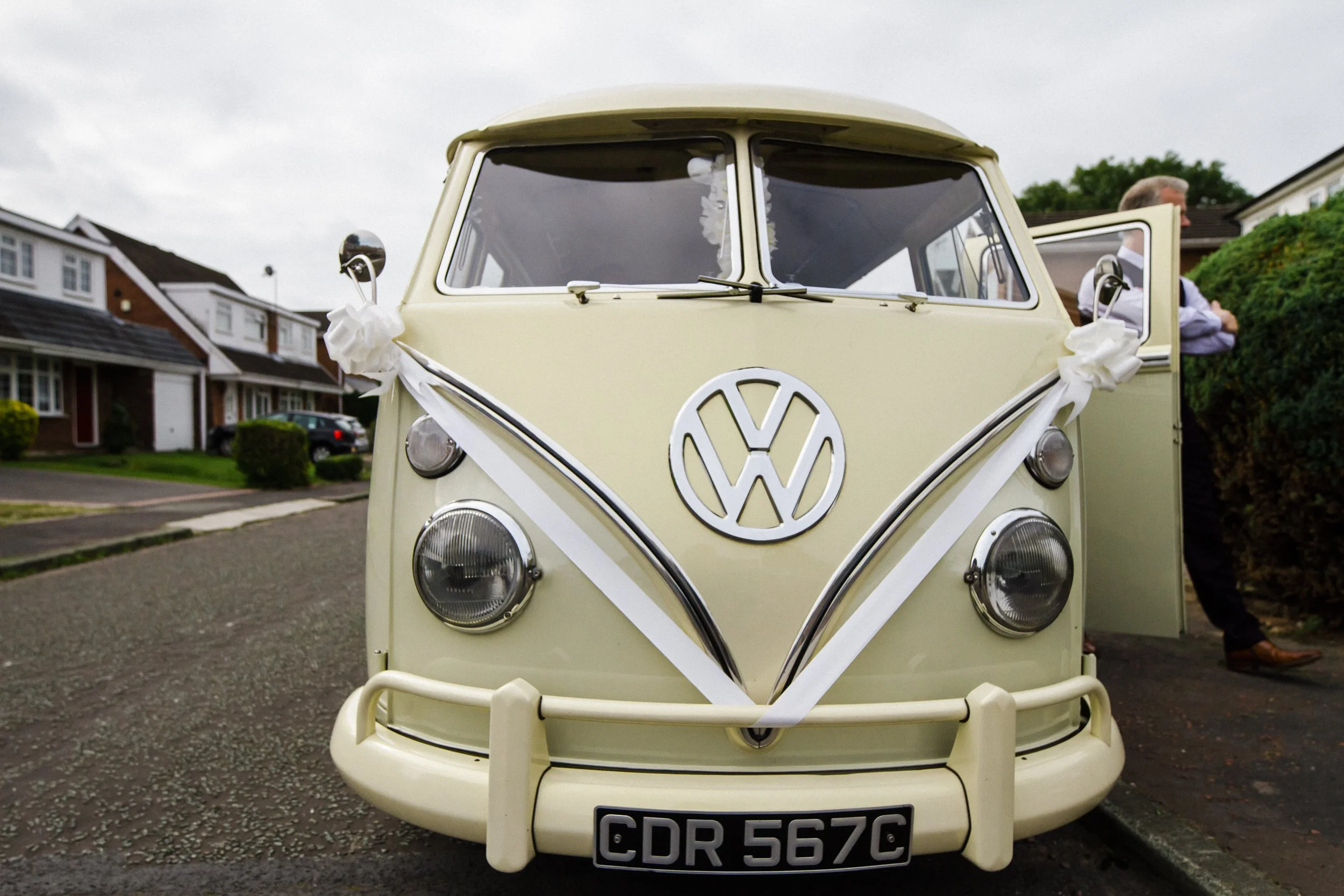 Surprise Arrival: A Wedding Camper Van Adds a Touch of Surprise and Delight for the Groom and Groomsmen, Captured in a Candid Moment by the Brook Hall Wedding Photographer
