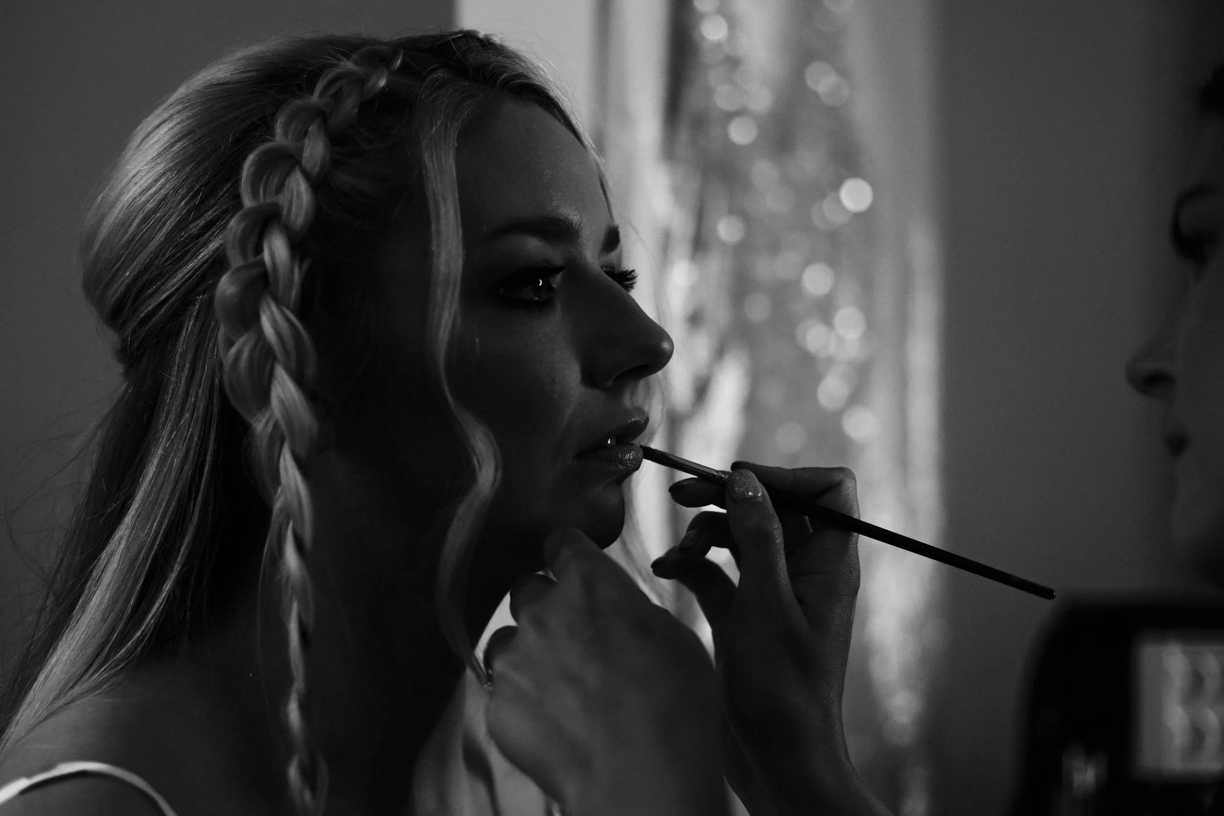 Perfect Pout: The Bride Gets Her Lipstick Applied, Adding the Final Touch to Her Wedding Look, Skilfully Captured at the Brook Hall  Hotel Wedding 