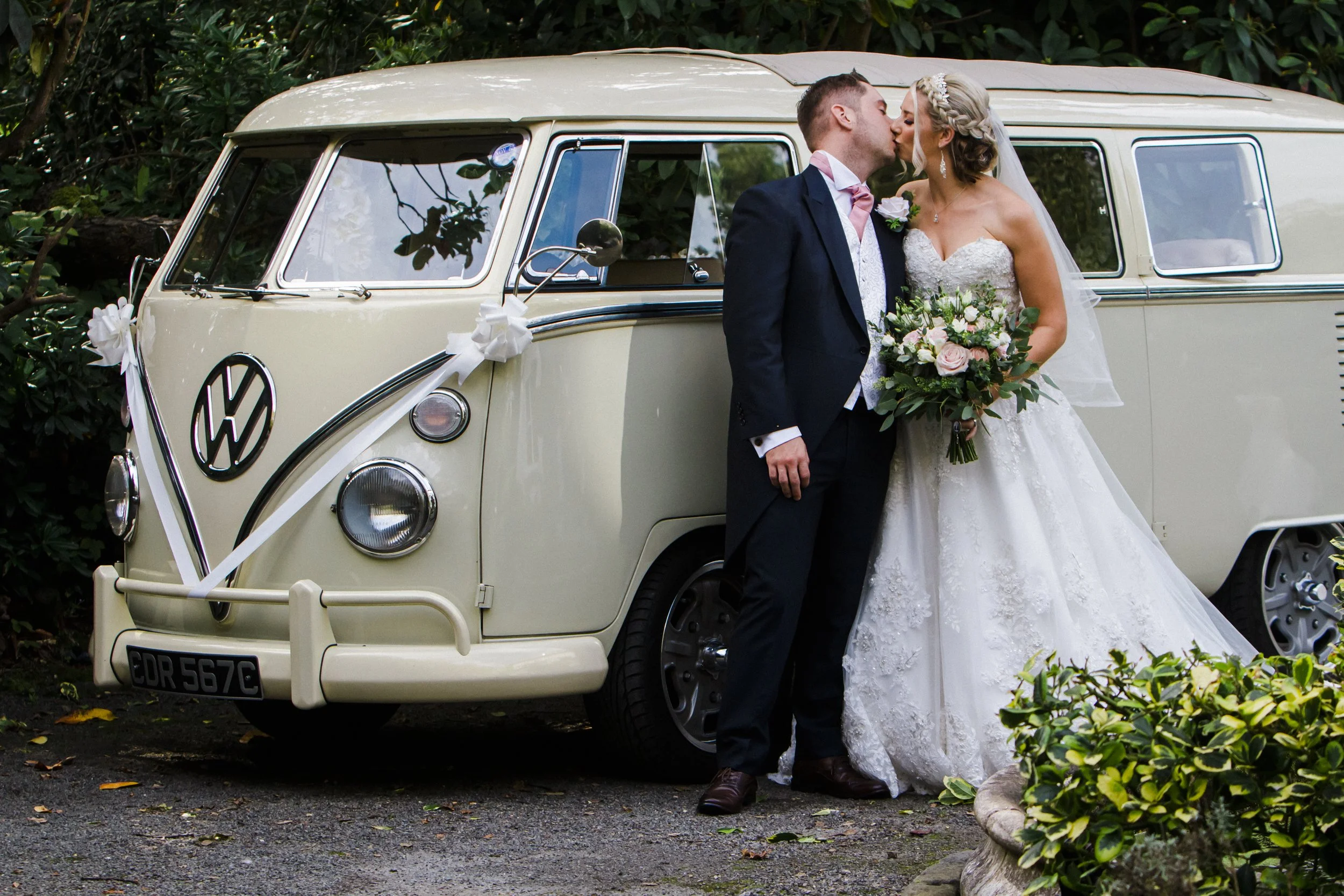 Bride and Groom Share a Loving Kiss Next to a Camper Van in this Beautiful Brook Hall Hotel Wedding Photography.