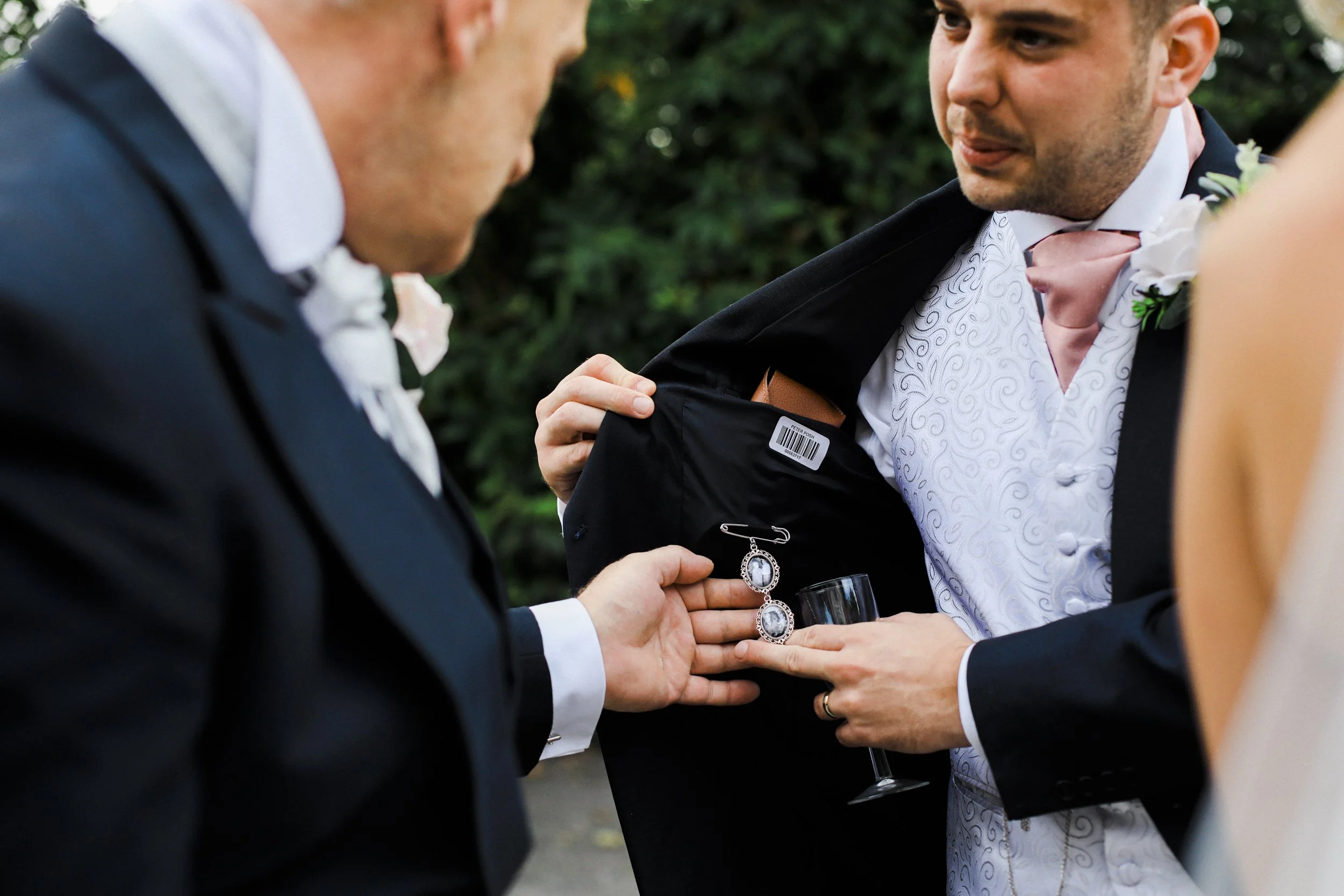 details of loved ones inside the jacket of grooms suit Brook Hall hotel wedding photography
