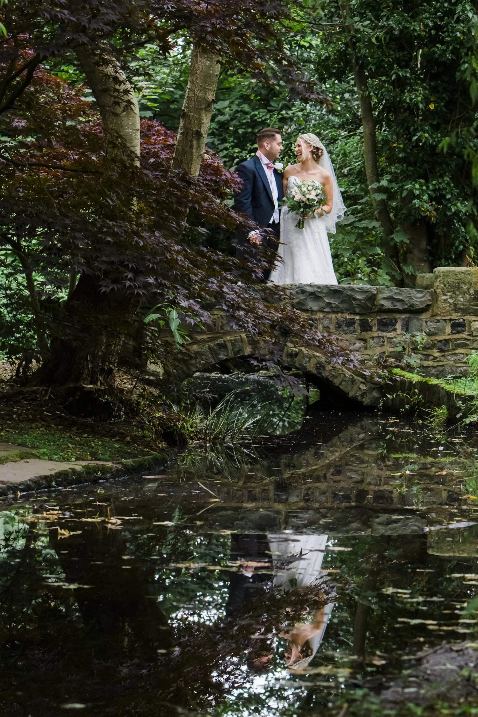 Brook Hall hotel wedding photography reflections in the water of bride and groom 