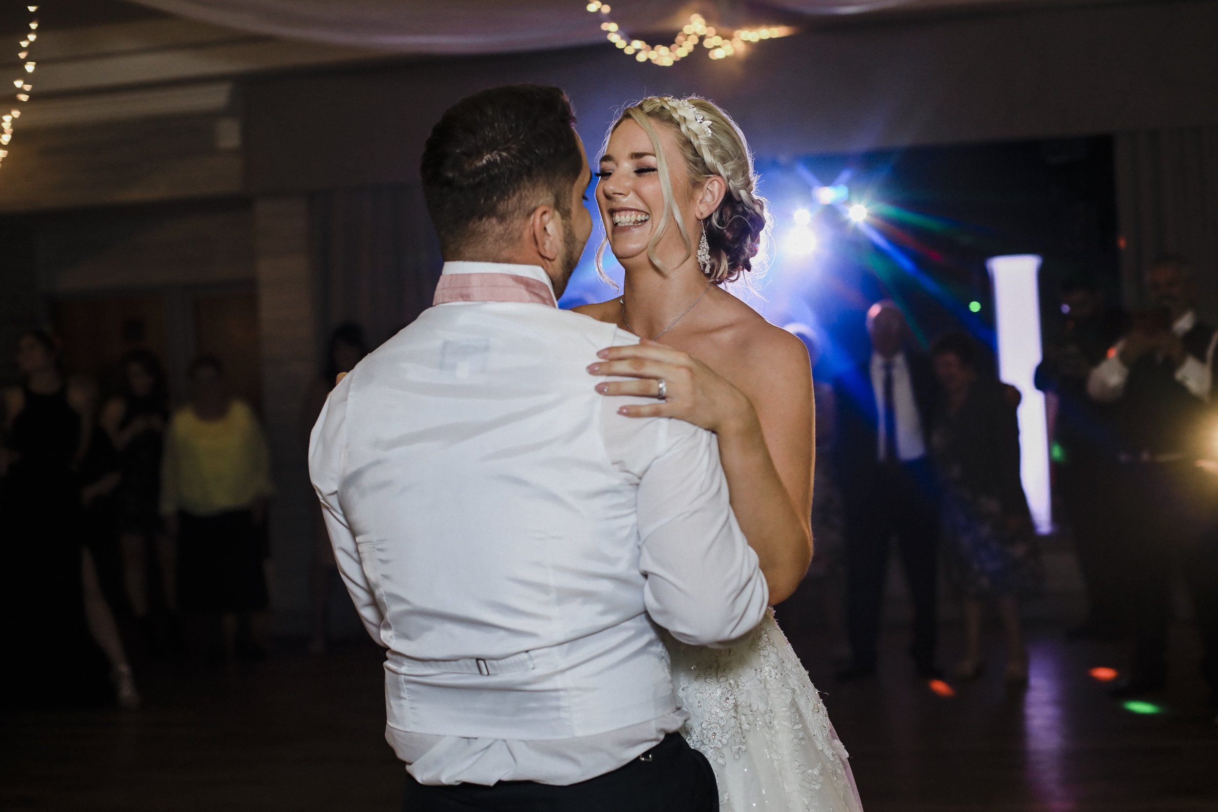 bride laughing during first dance Brook Hall hotel wedding photography