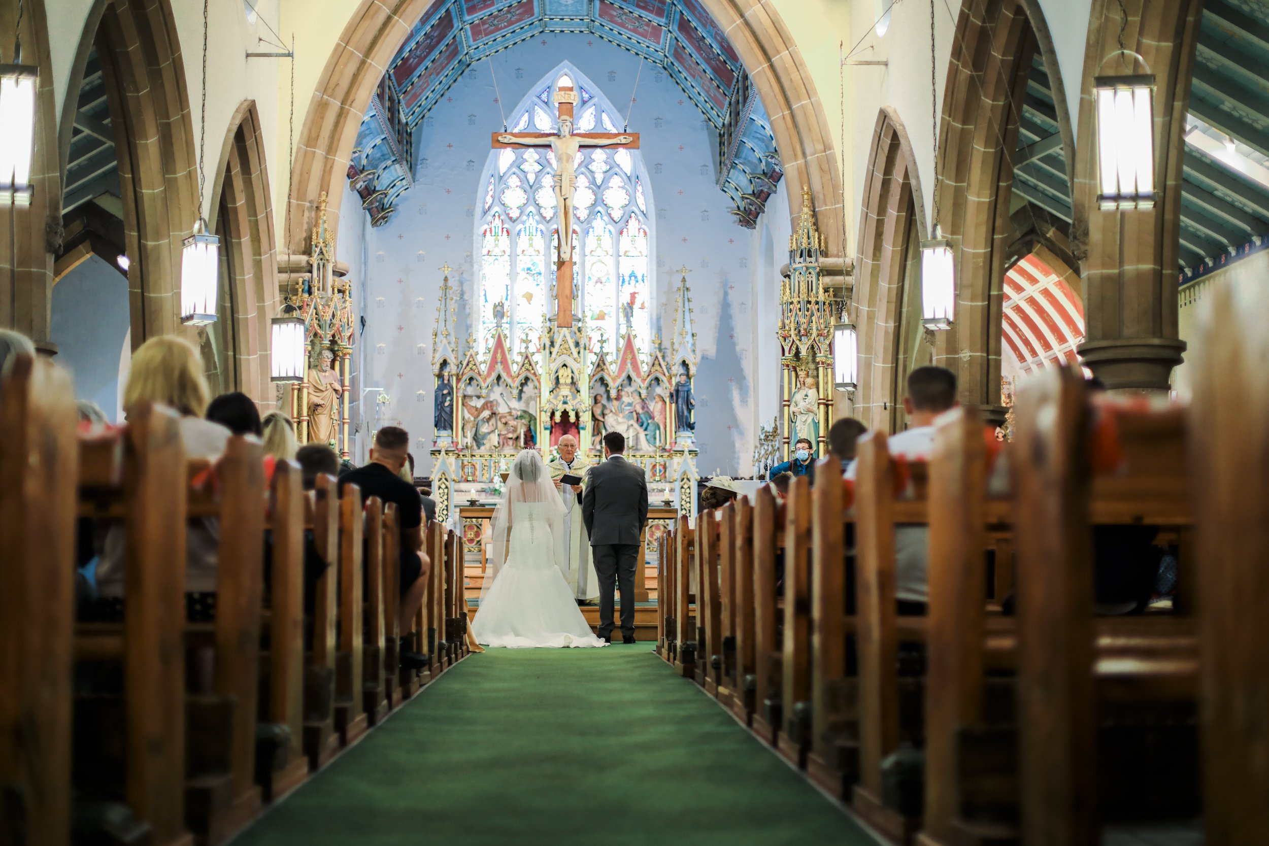 Central Stage: Bride and Groom Stand at the Front of the Grand St. Anne's Church in Ormskirk, Creating a Captivating Focus.