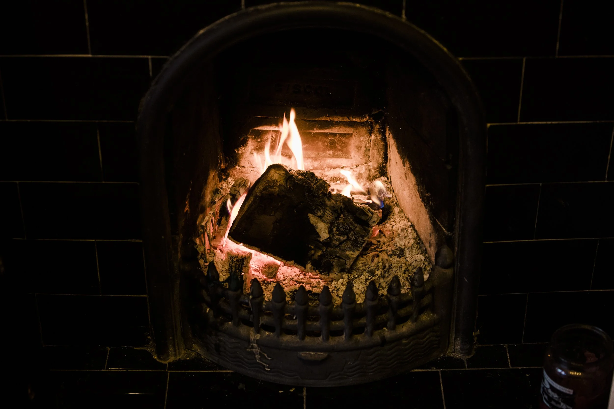 Bride and Bridesmaids Getting Ready in the Warmth of a Cosy Fire at a Wirral Winter Wedding.