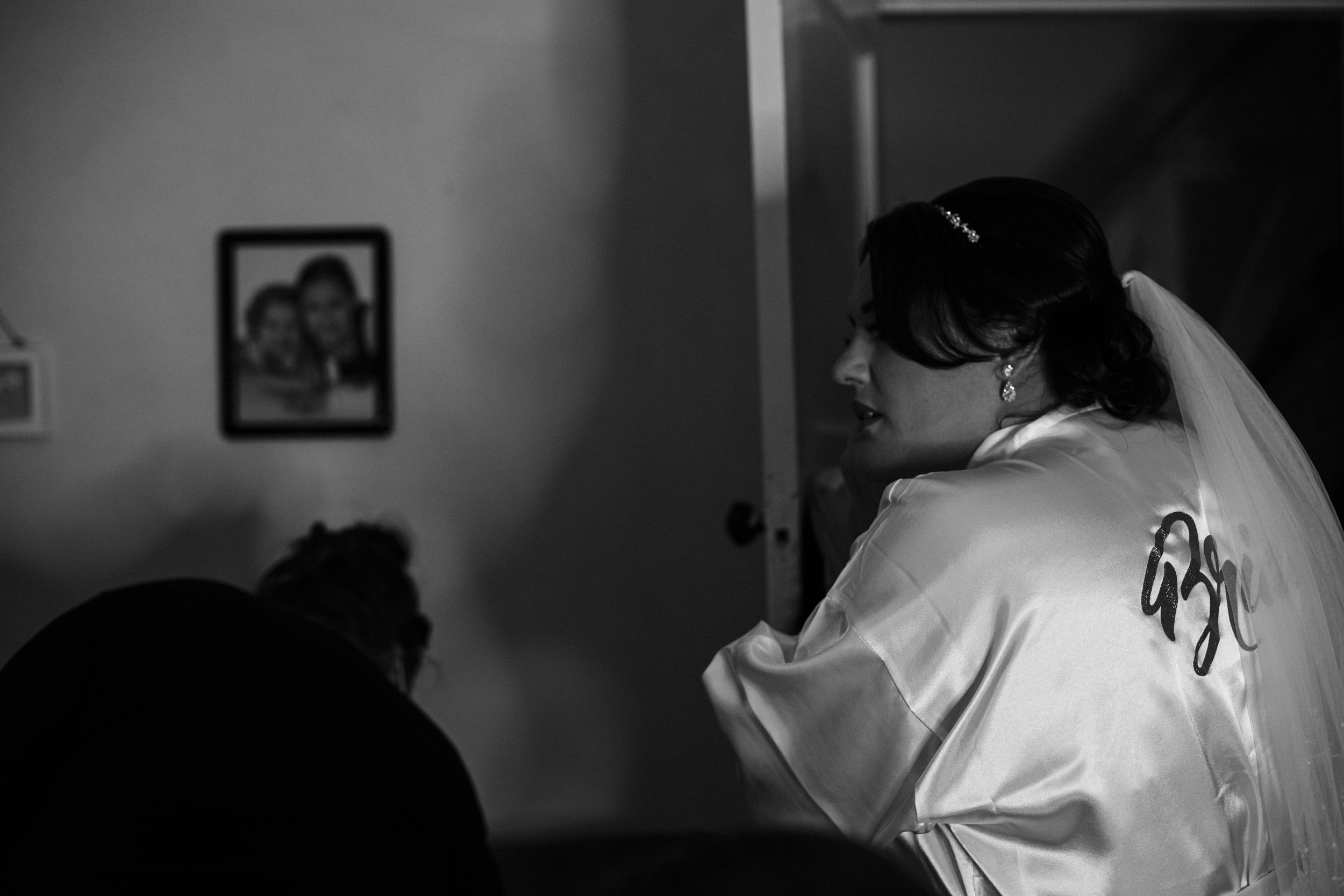 Winter Bridal Prep: Candid Moments as the Bride puts her earrings in on a Beautiful Wirral Winter Morning