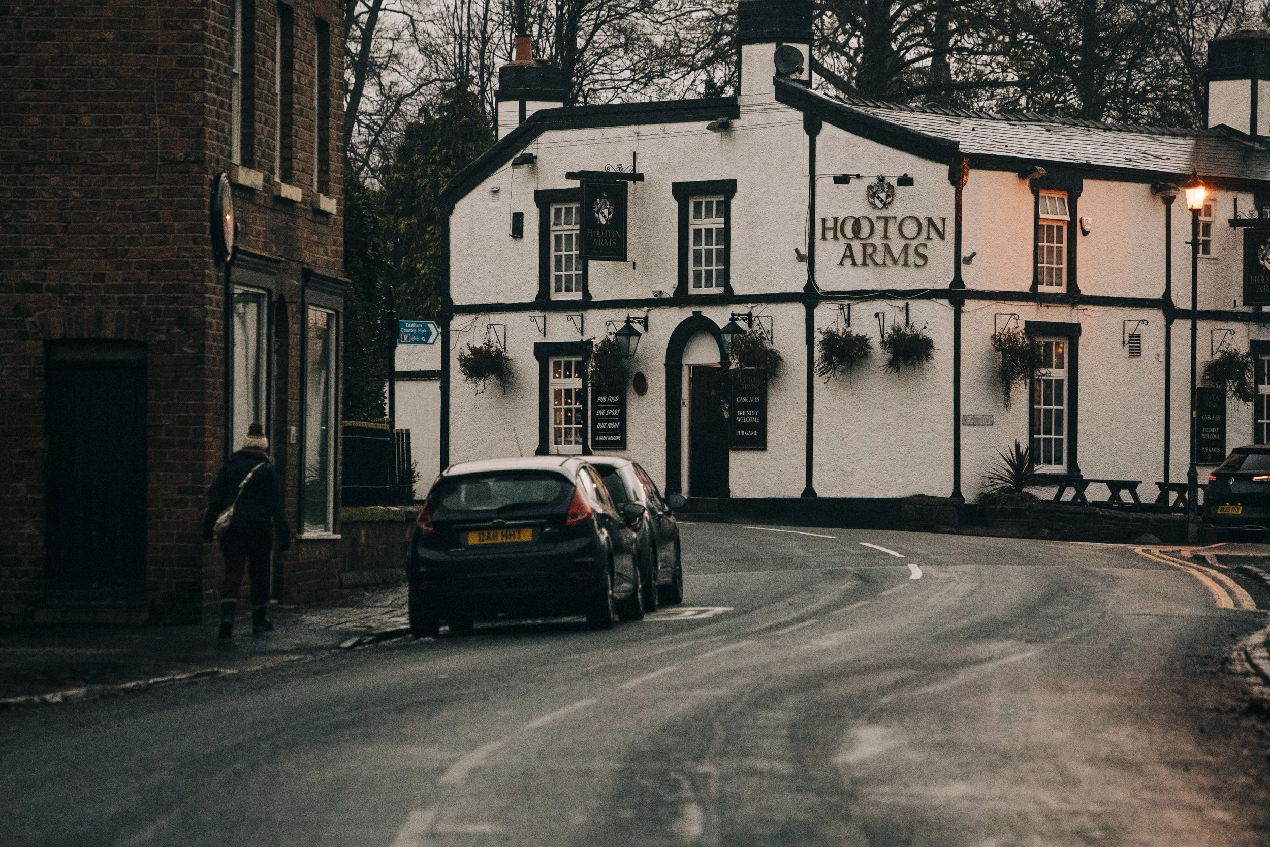 Warm Gathering: Groom and Groomsmen Meet and Greet Guests at a Cosy Local Pub 