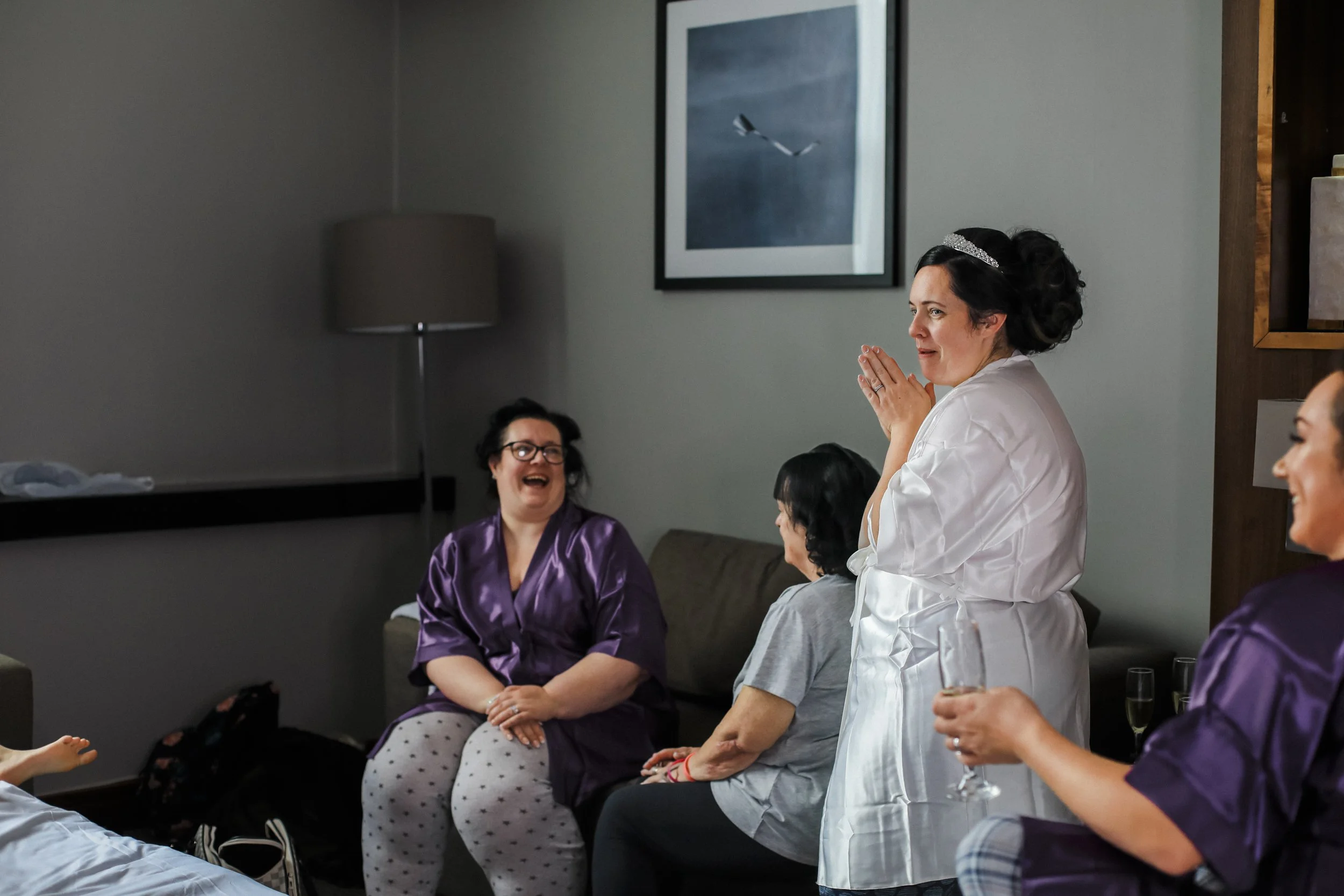 bride and bridesmaid laughing and joking the morning of the big day Formby Hall Sefton Wedding Photography