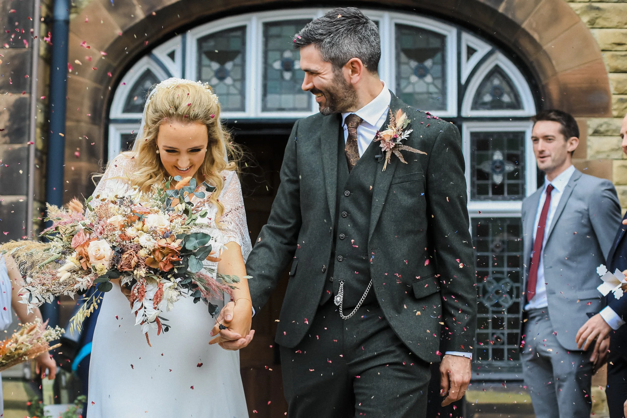 oyful newlyweds exit ceremony amidst celebratory confetti at Liverpool's Oh Me Oh My, beautifully captured in this Liverpool wedding moment