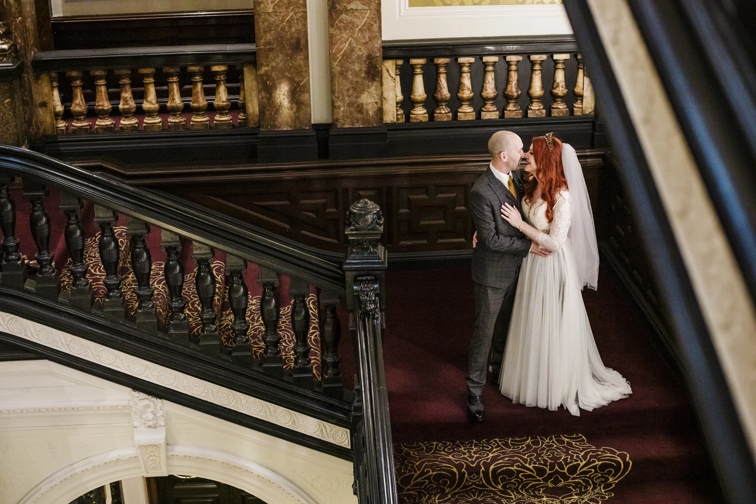 Friday the 13th Liverpool wedding: Bride and groom striking a pose on the stairs of the Corinthian Grand in Liverpool.