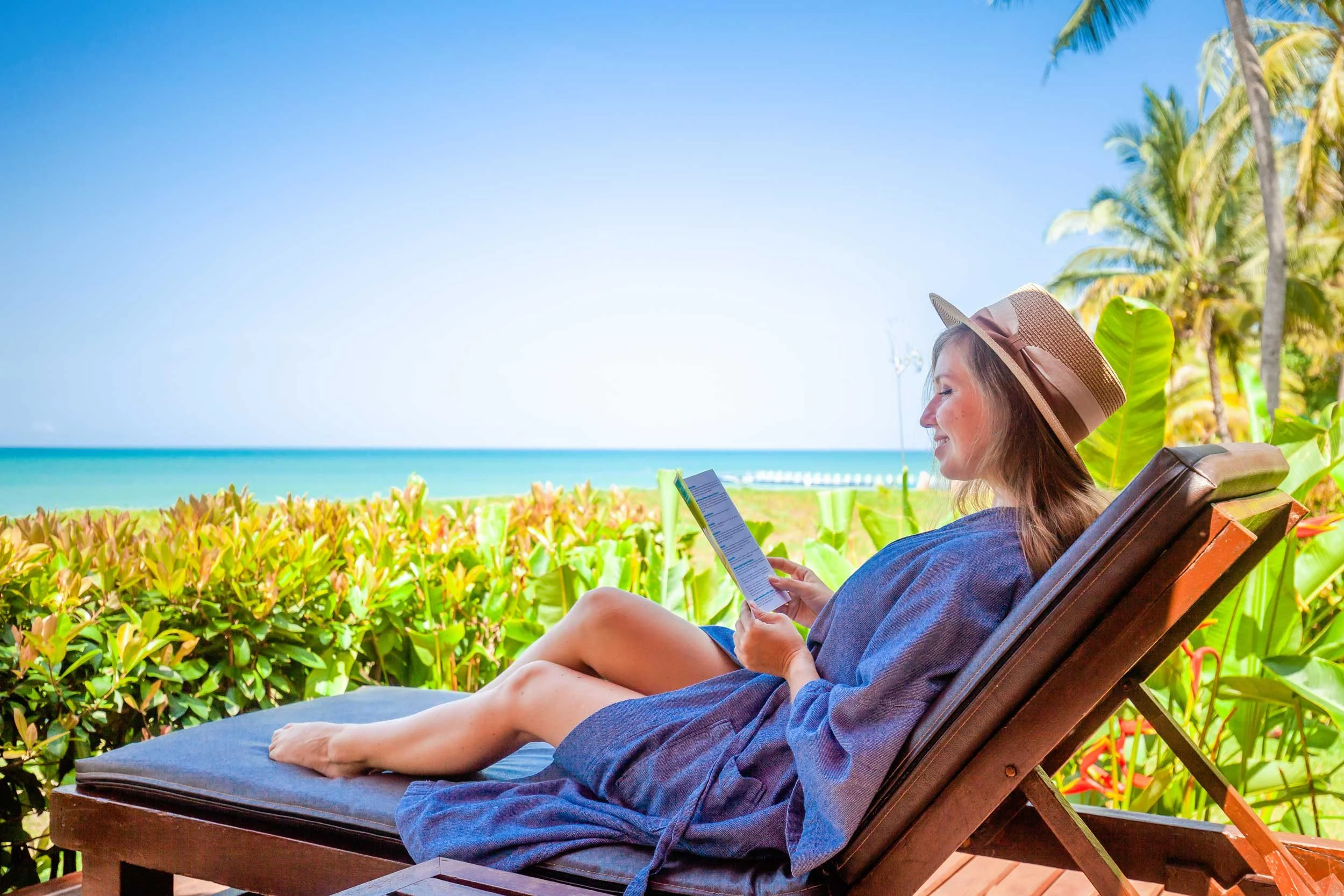 A woman reading at the beach.