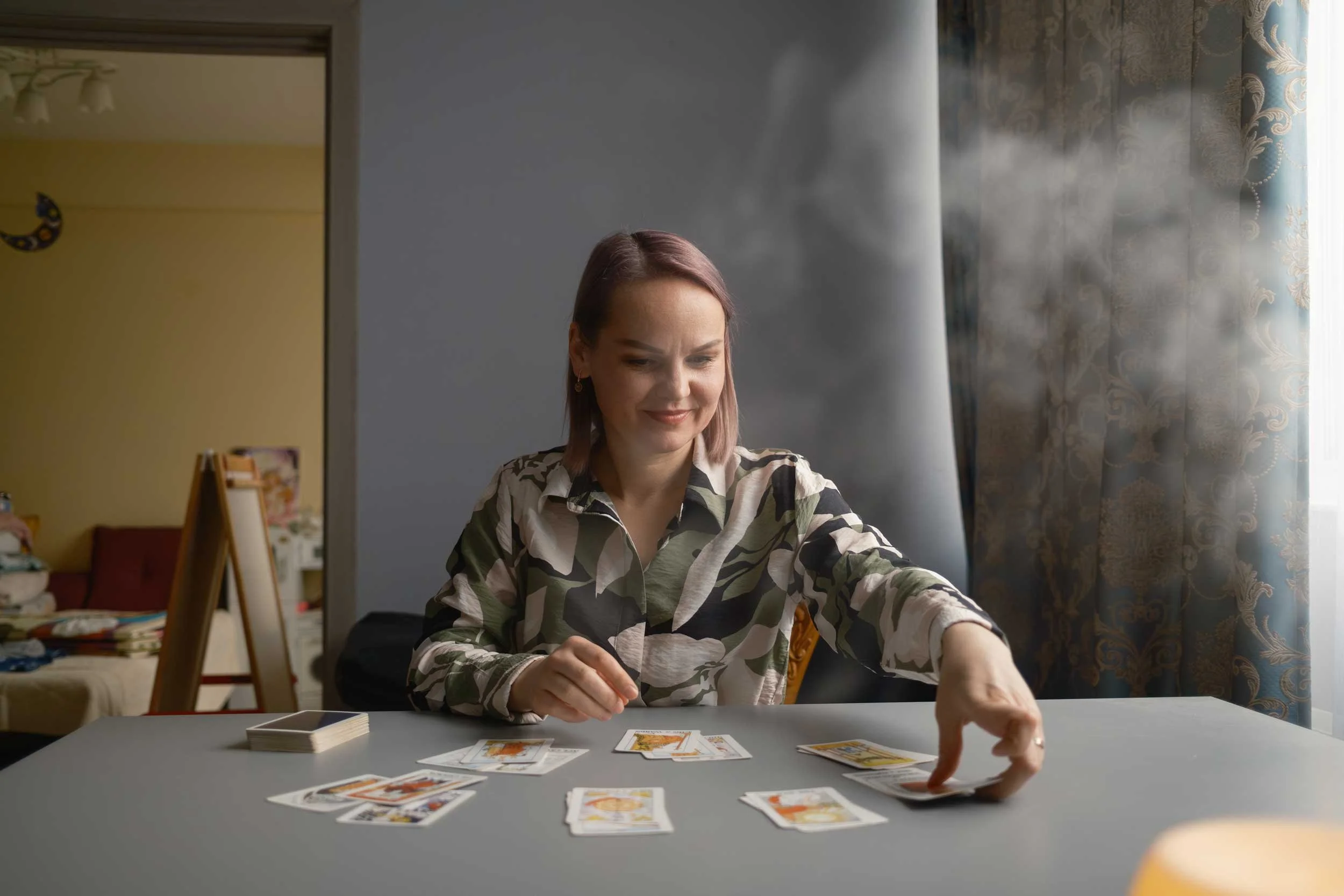 A woman reading her cards in a cloud of incense.
