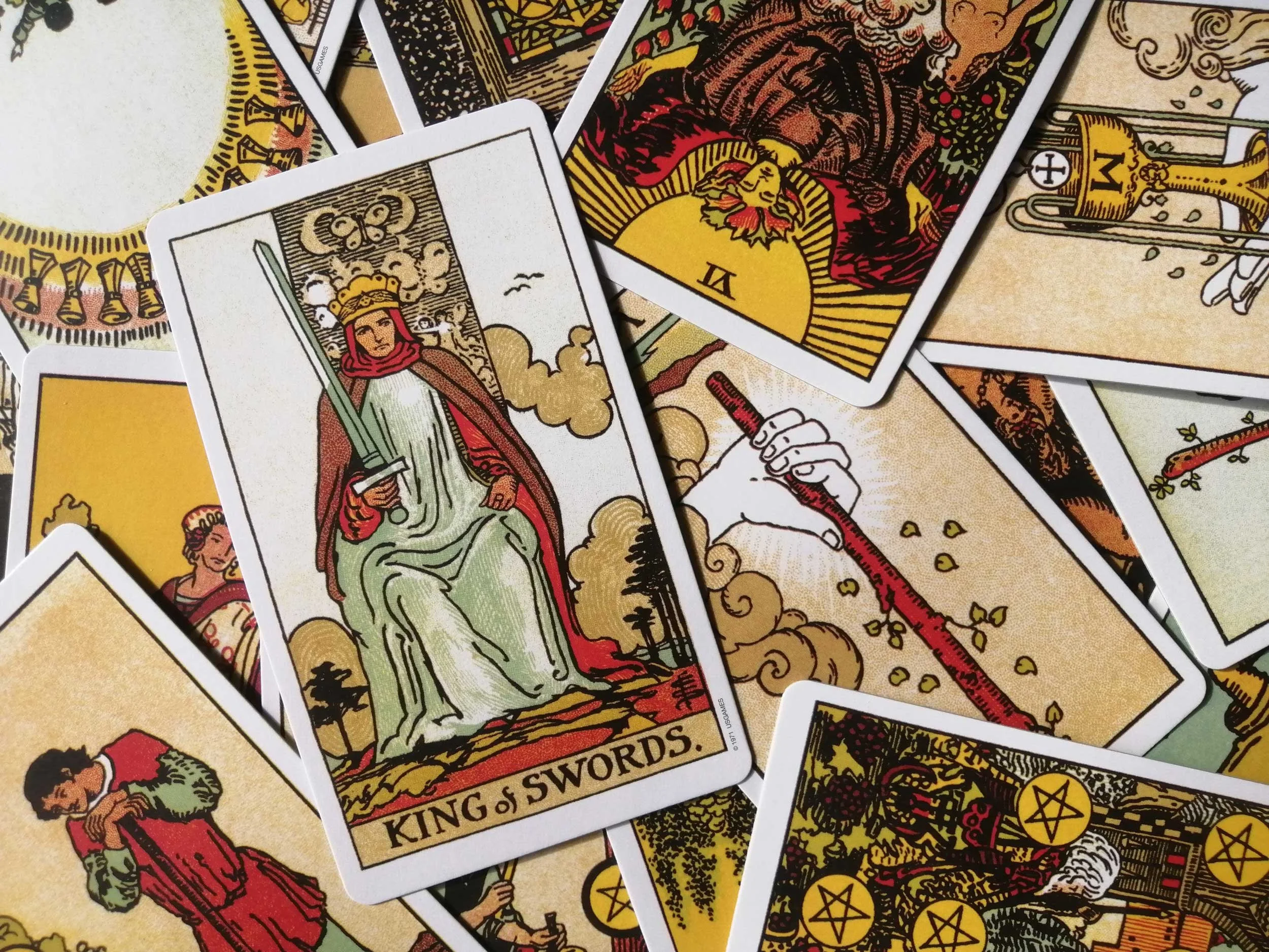 Tarot cards with a focus on the King of Swords.