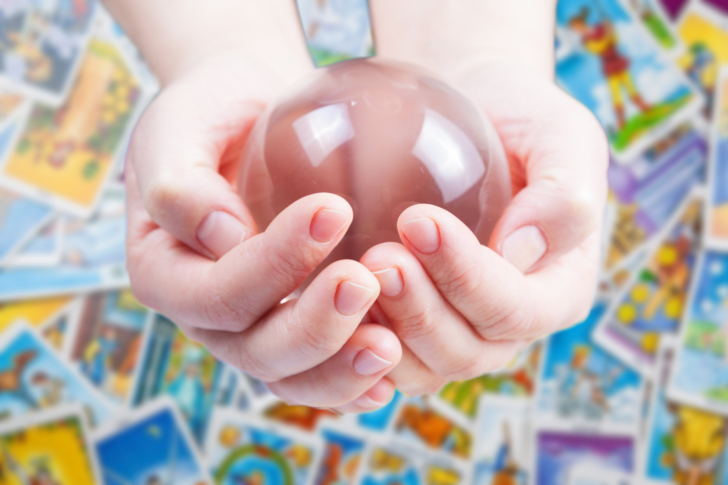 Hands holding magic crystal ball.