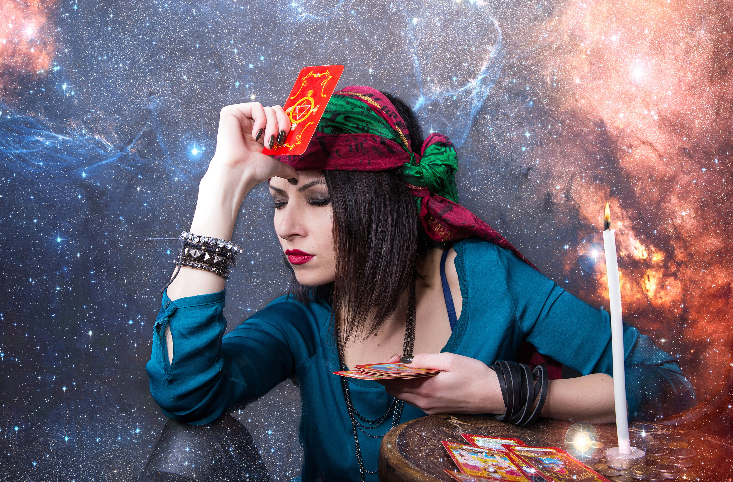 Young beautiful fortune teller wondering on the Tarot cards. Predicting the future, access to the astral