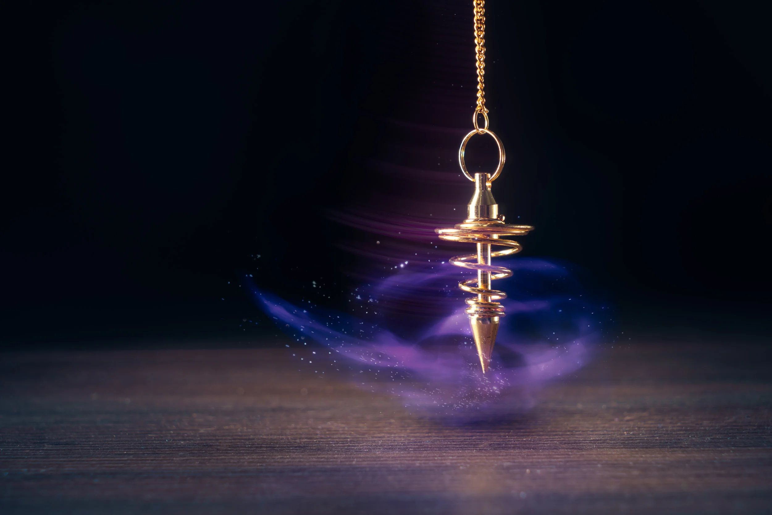 Pendulum used for readings and hypnotism swinging with motion blur