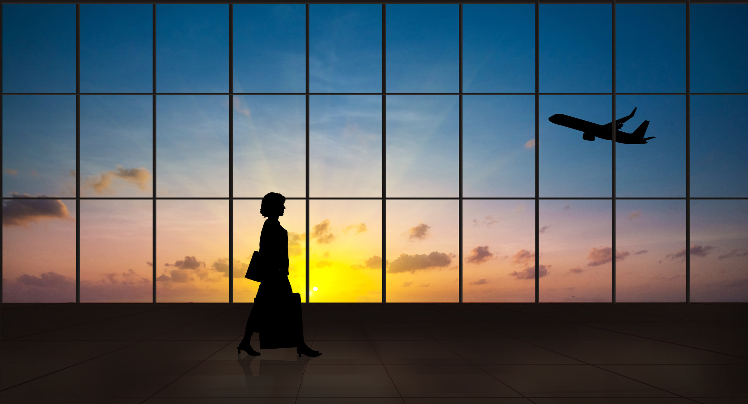 Business woman walking alone silhouette in the airport