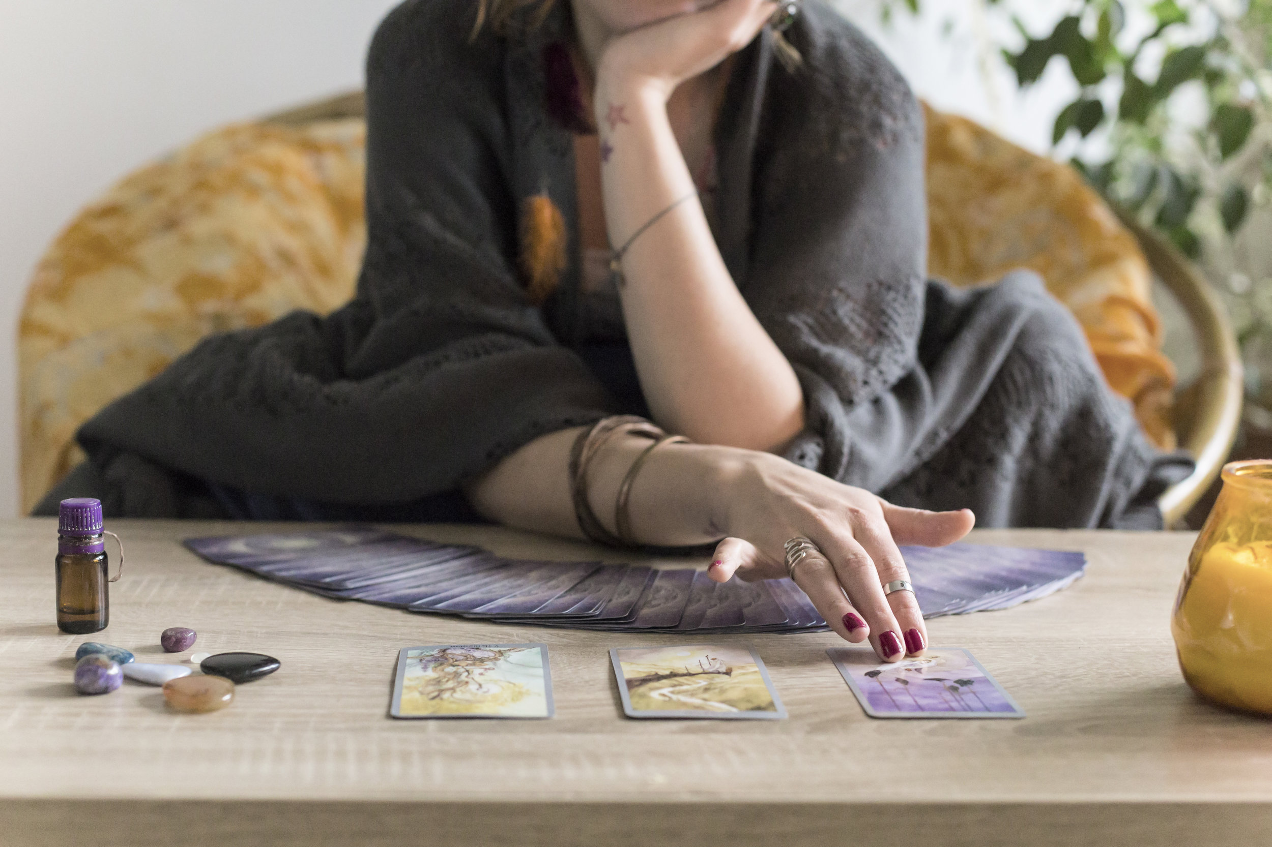 Young redheaded woman reading tarot fortune