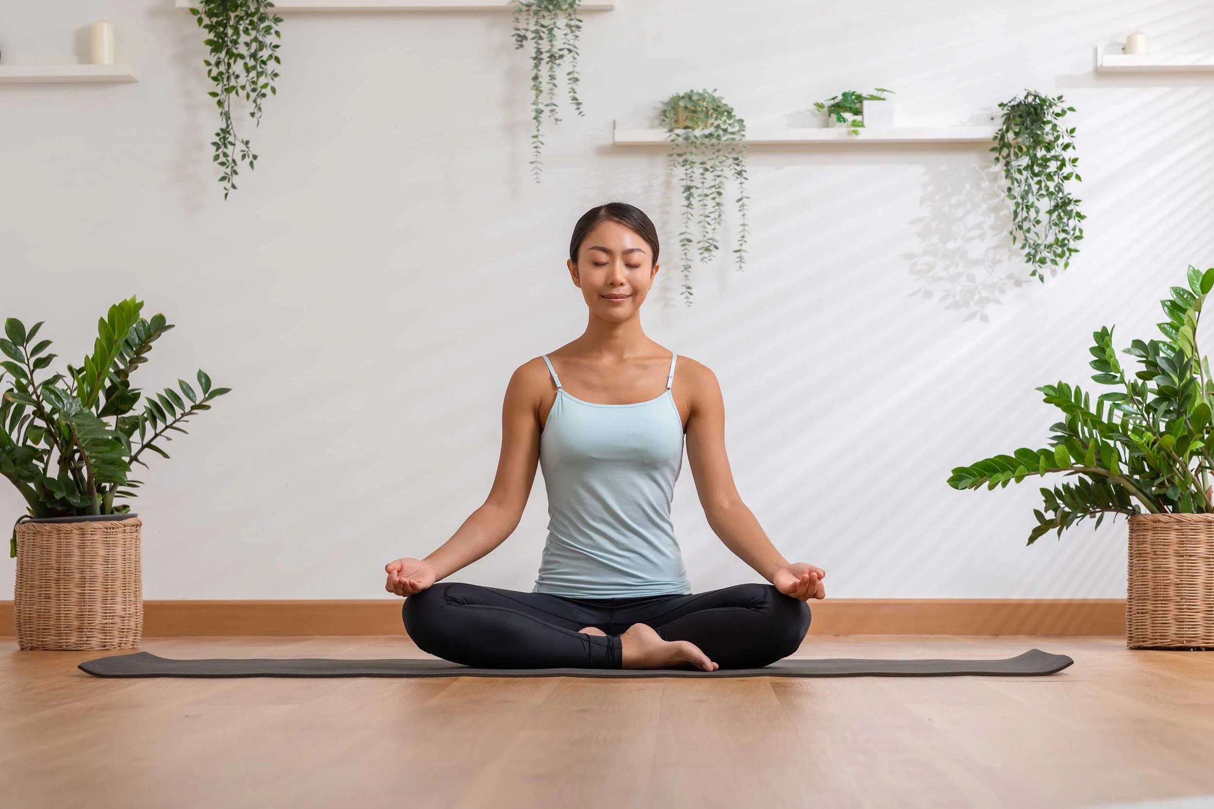 A woman meditating on her yoga mat.