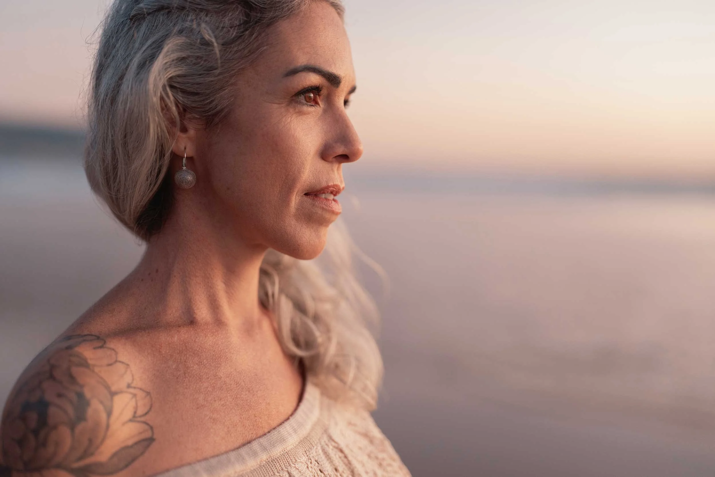 A woman in contemplation at the beach.