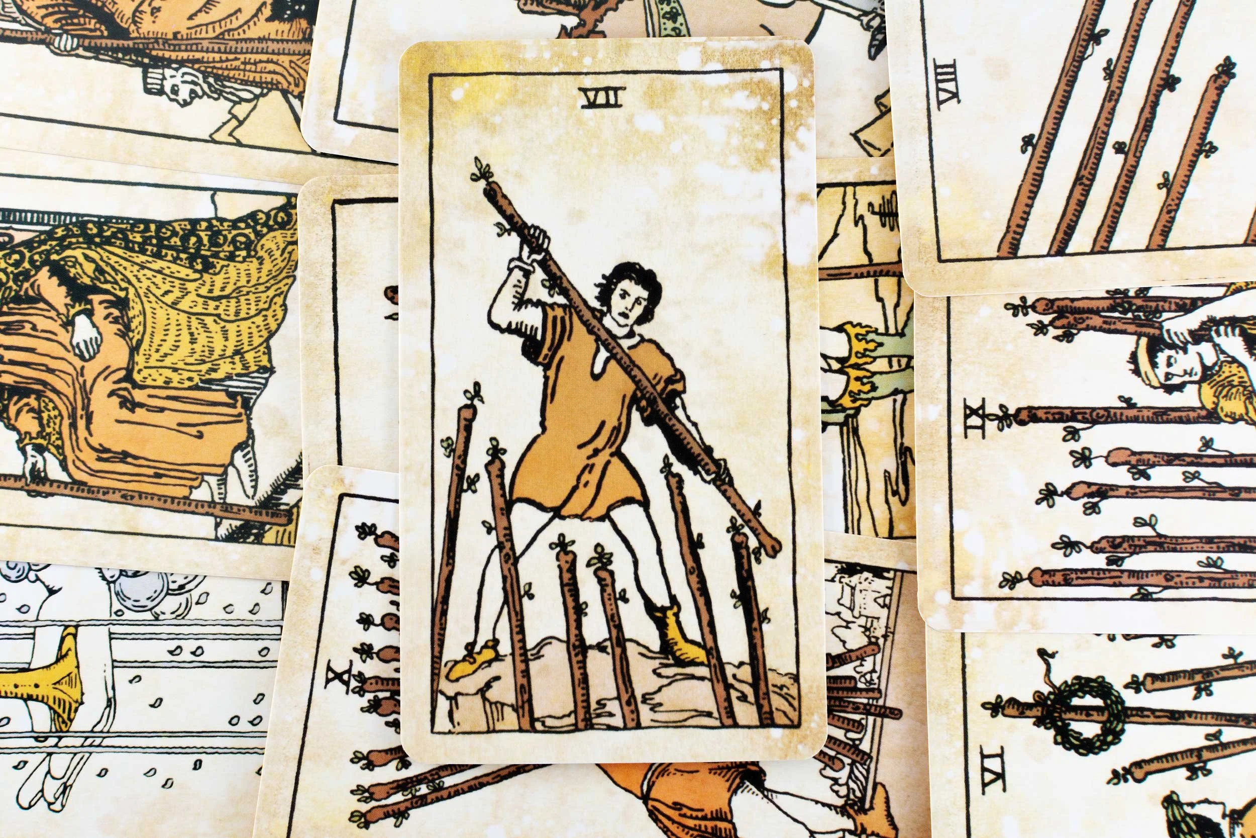 Tarot cards with a focus on the Seven of Wands.
