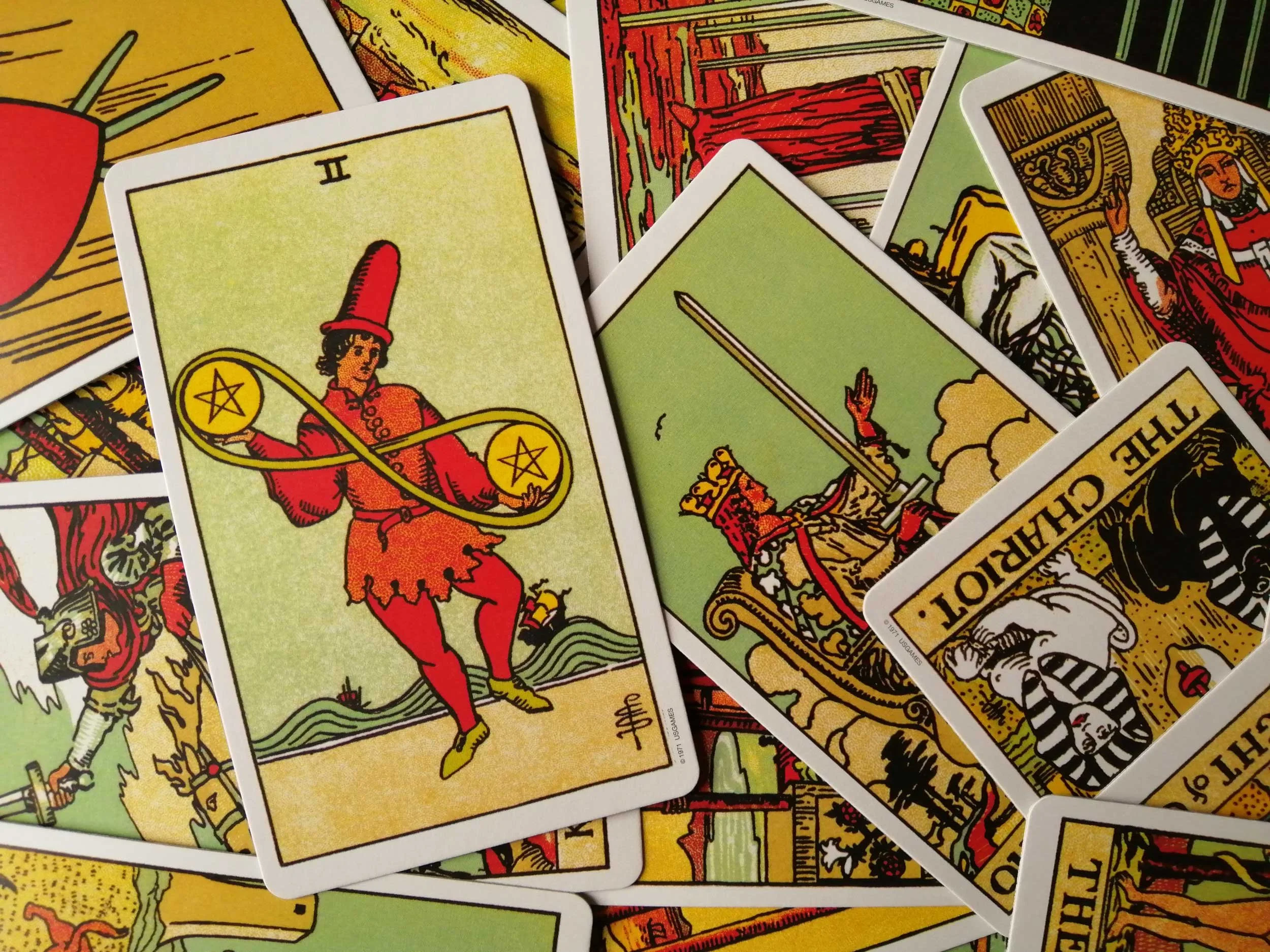 Tarot cards with a focus on the Two of Pentacles.