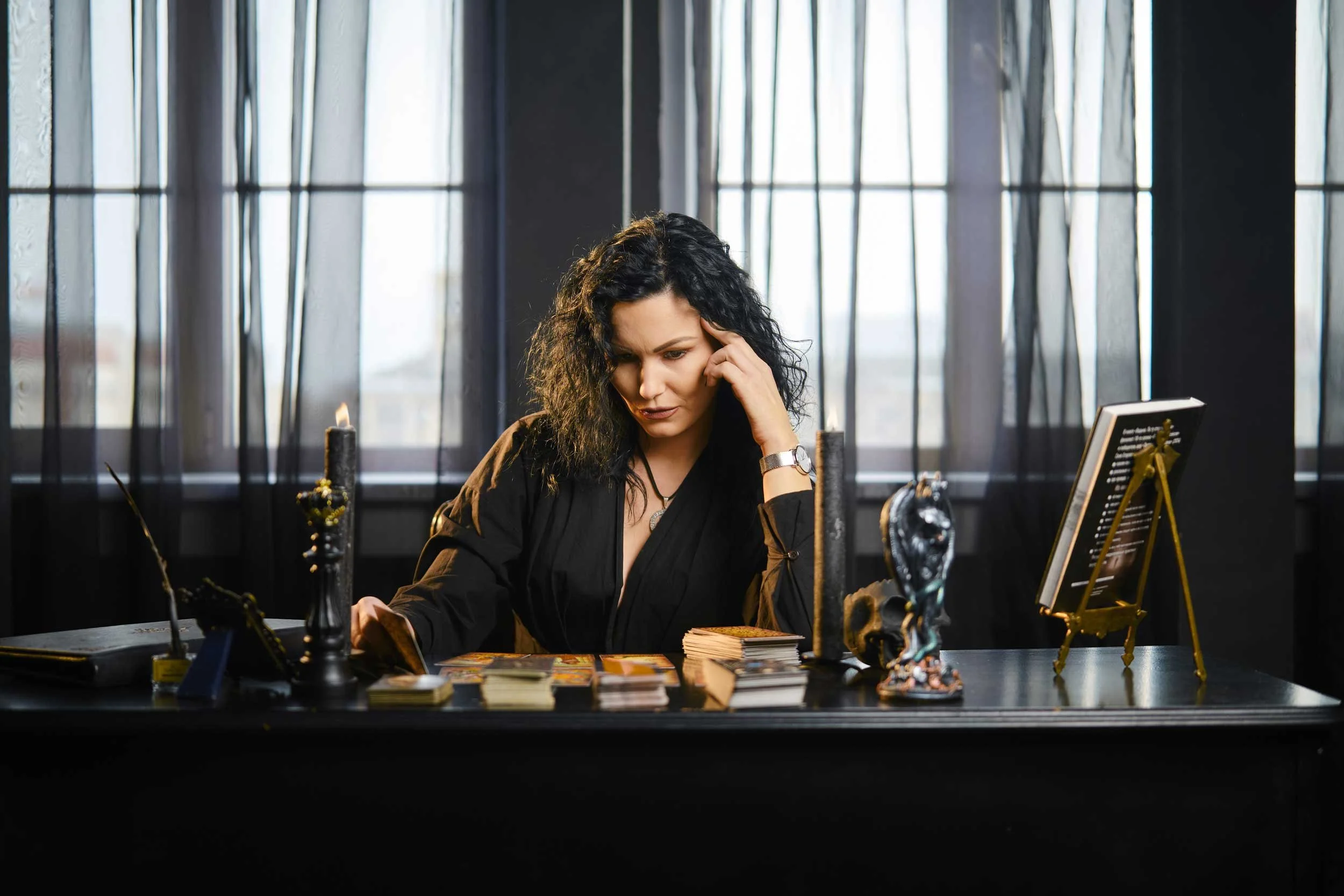 A tarot reader contemplates her reading.