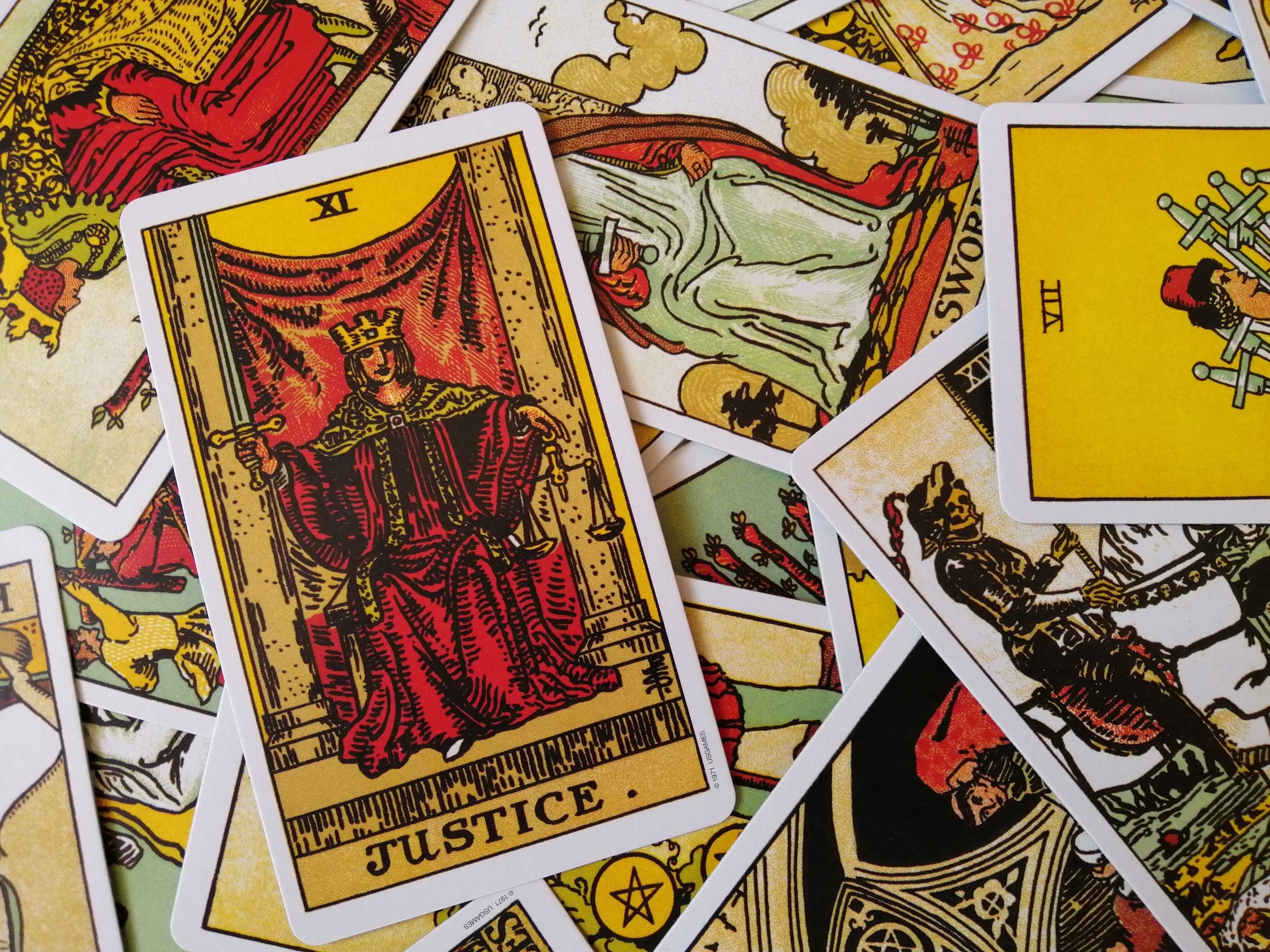 Tarot cards with a focus on the Justice card.