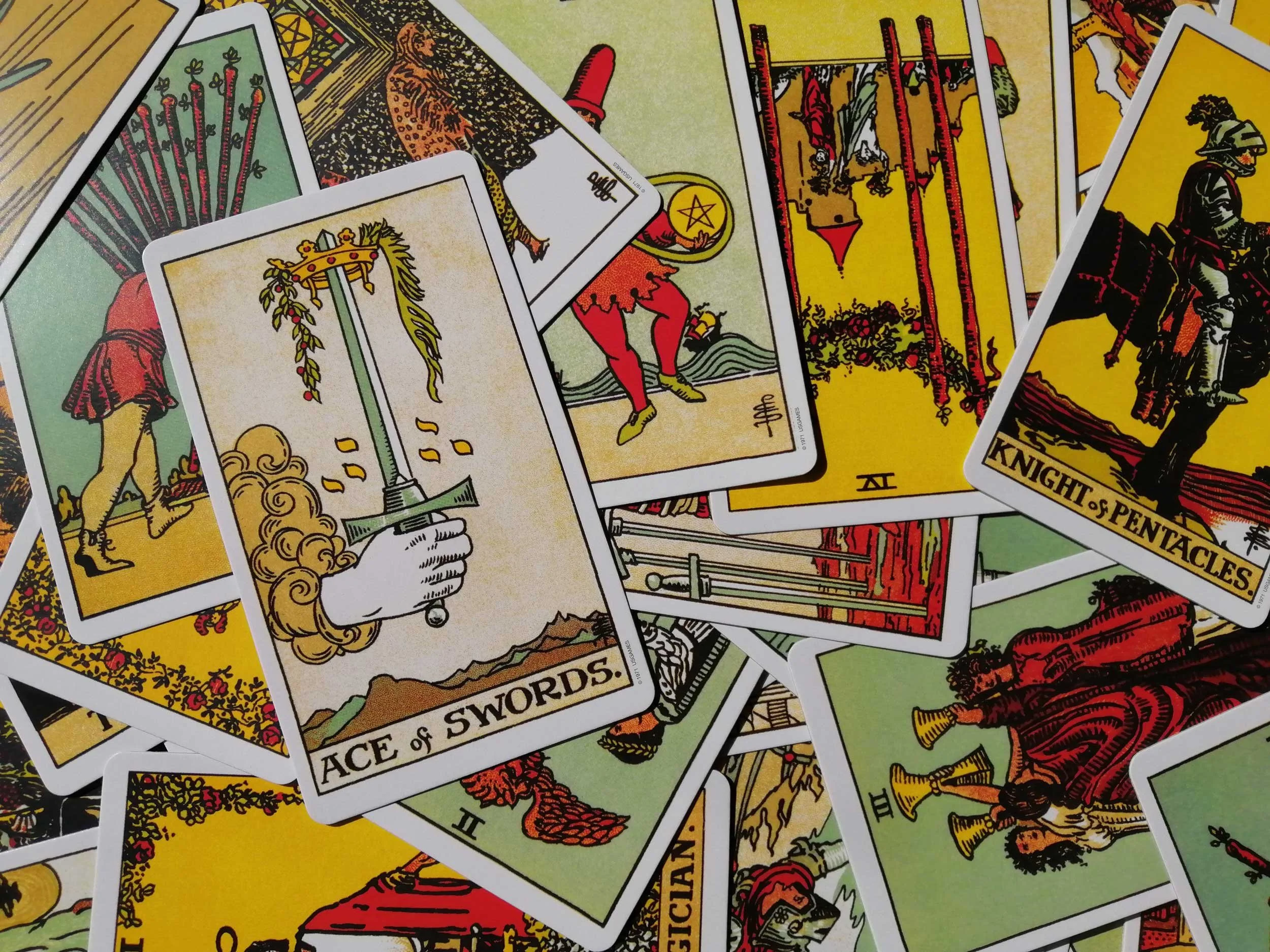 Tarot cards with a focus on the Ace of Swords.
