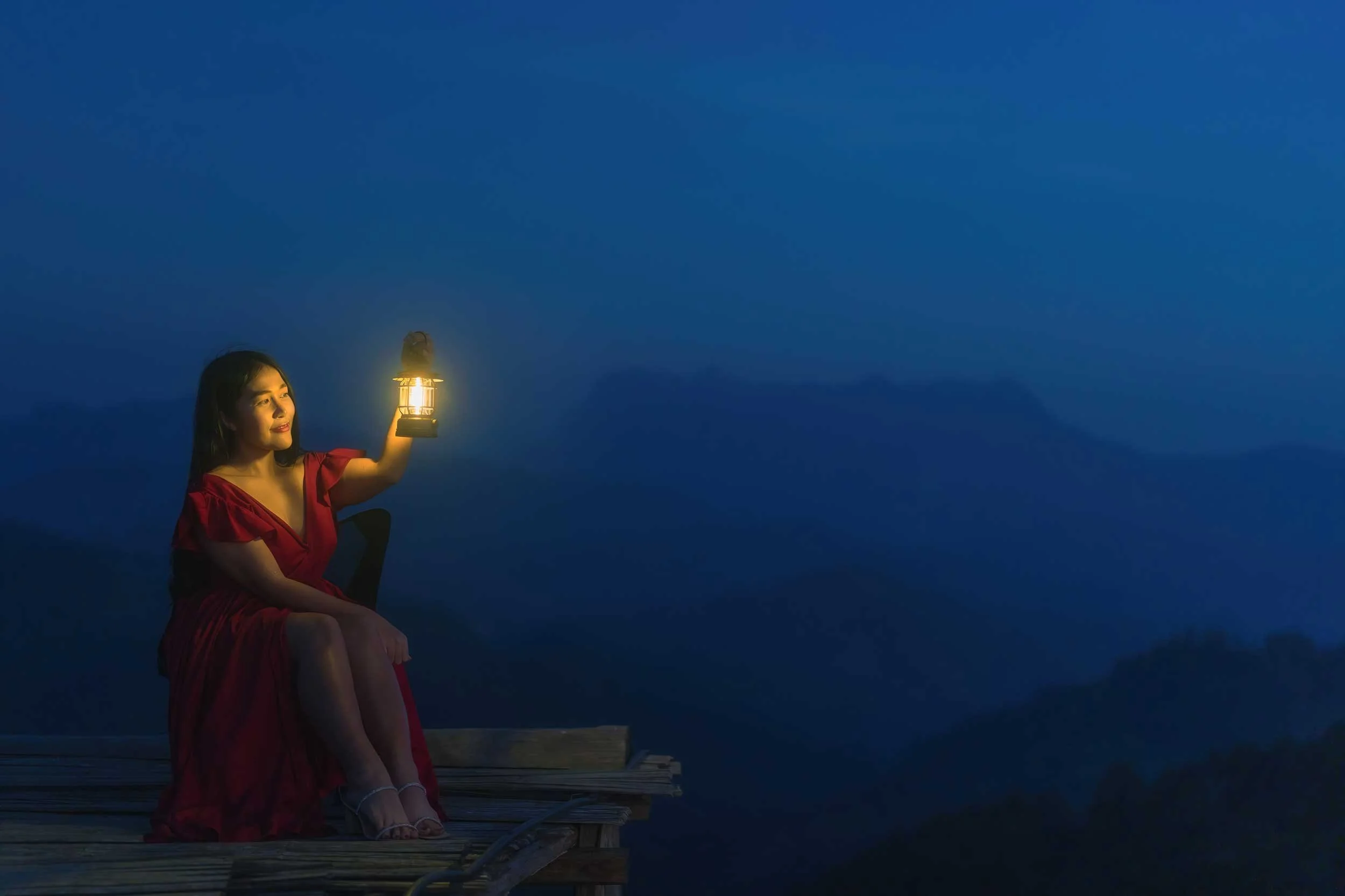 A woman holding a lantern.