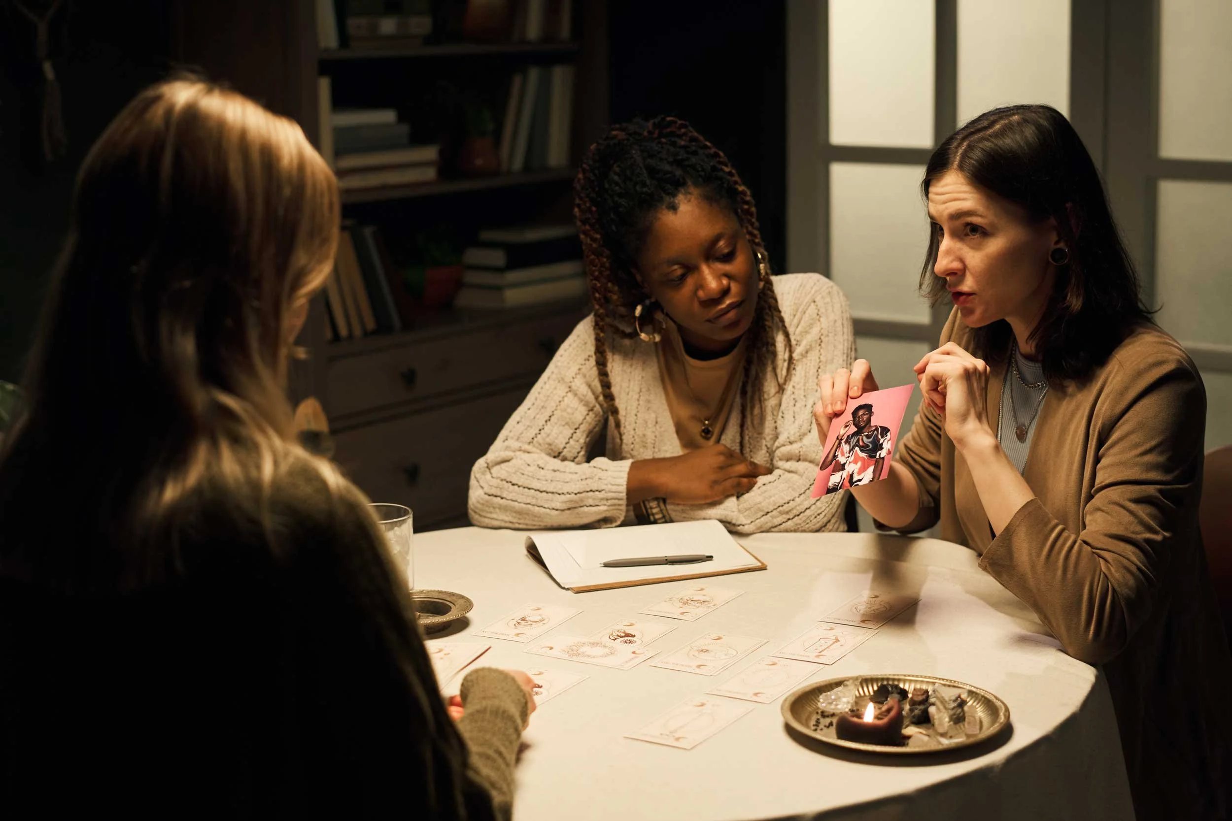 A group of people reading tarot.