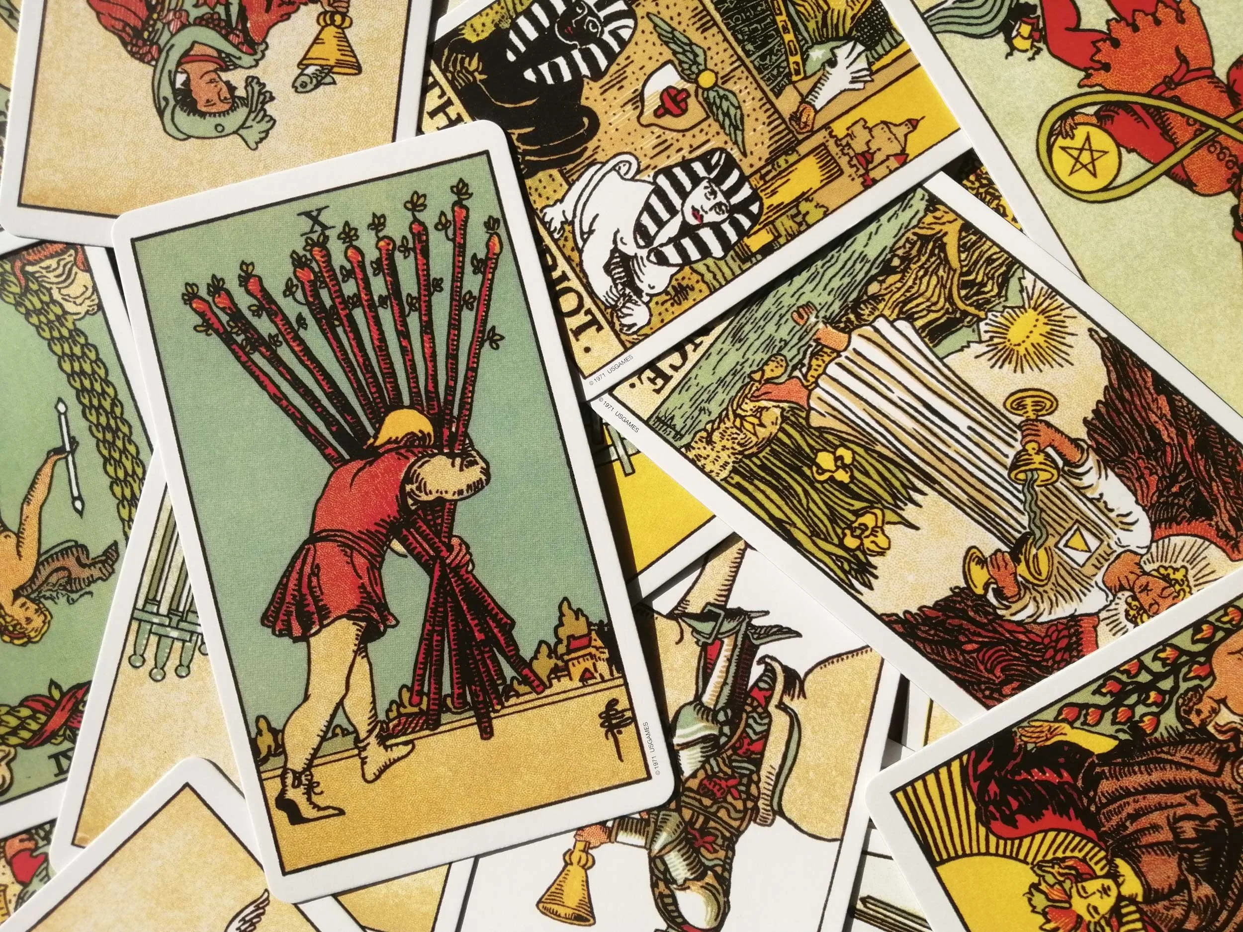 Tarot cards with a focus on the Ten of Wands.