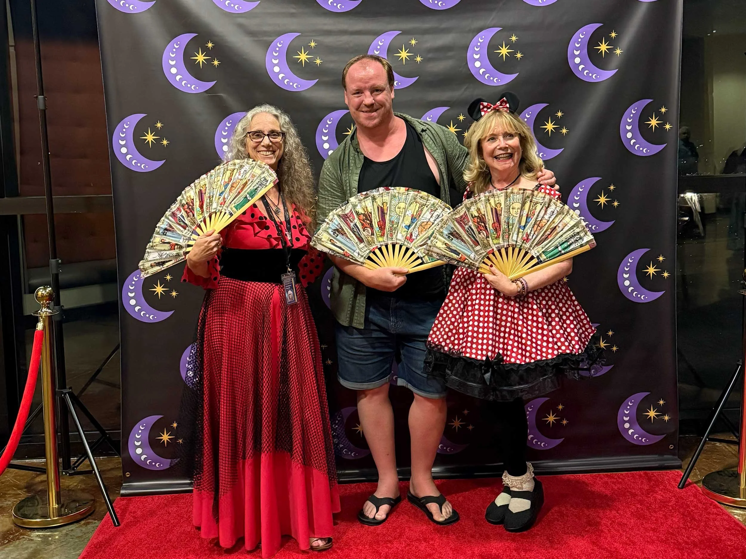Christiana, Pamela, and Ben on the red carpet at StaarCon 6, with tarot fans.