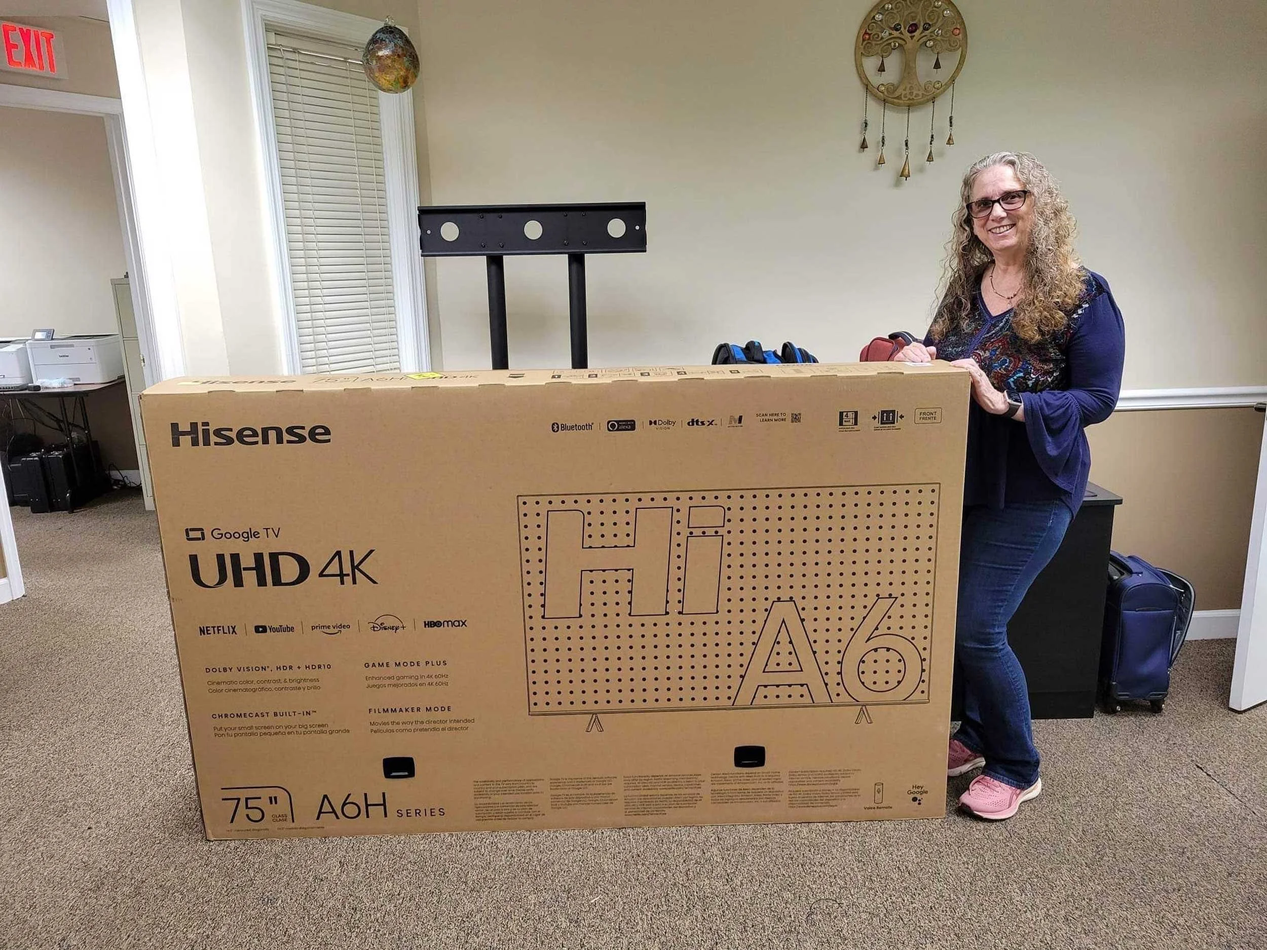 Christiana stands beside a boxed StaarCon television monitor.