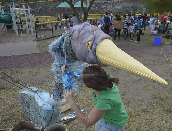 Joan Harmon putting the final touches on her "bird" sculpture.