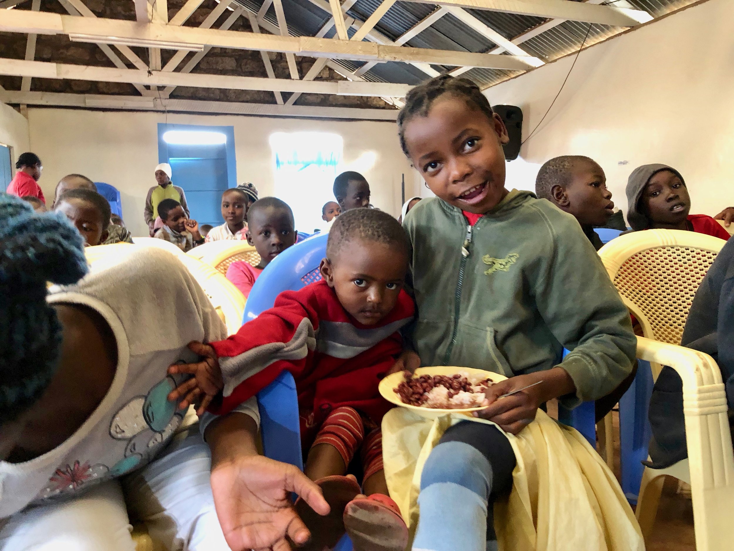 Children taking their lunch in the main hall