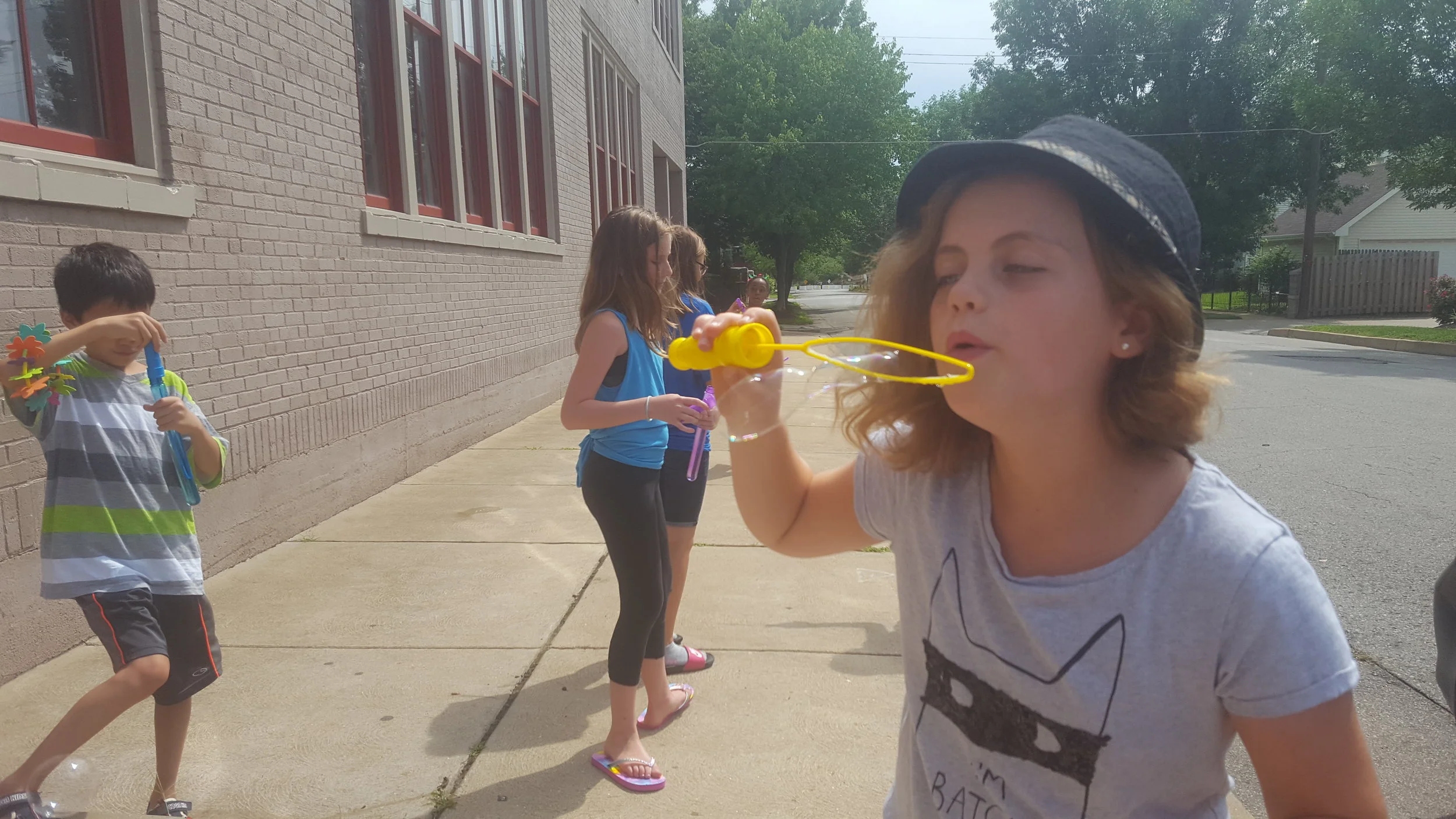 Students play with bubbles on a break between classes.