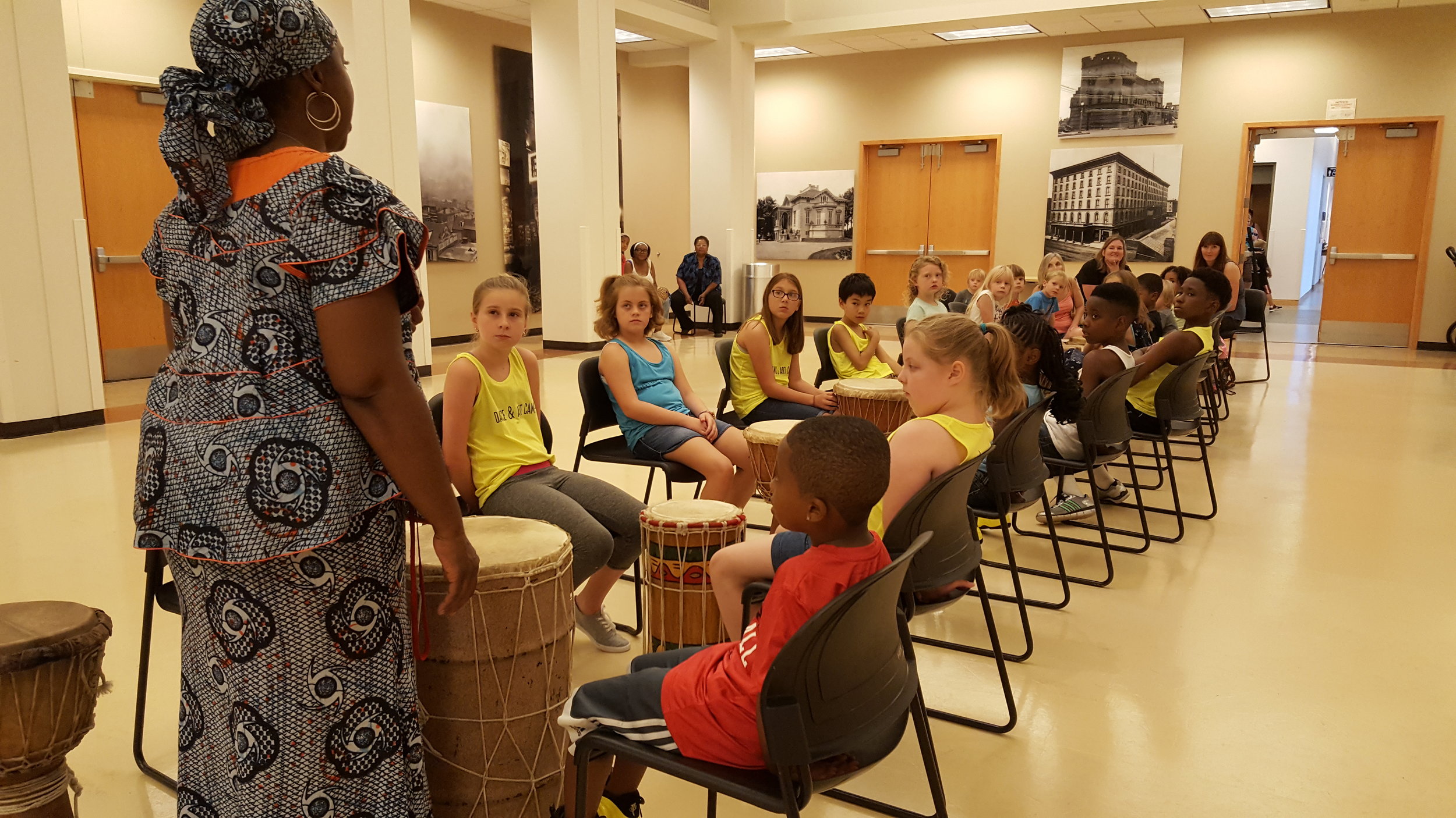 Students learn percussion/drumming skills from an educator at the St. Louis History Museum