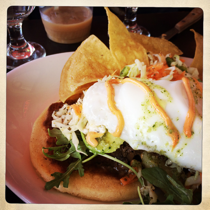 Vegetable papusas with fried egg on top at La Bomba
