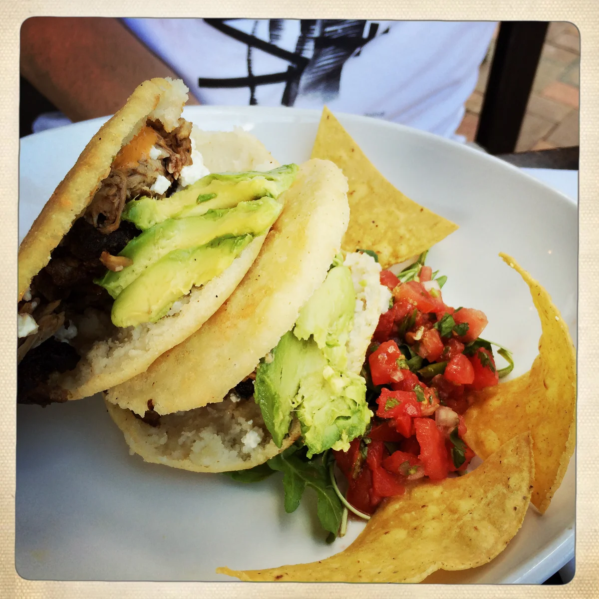 Arepas with pork carnitas and salsa