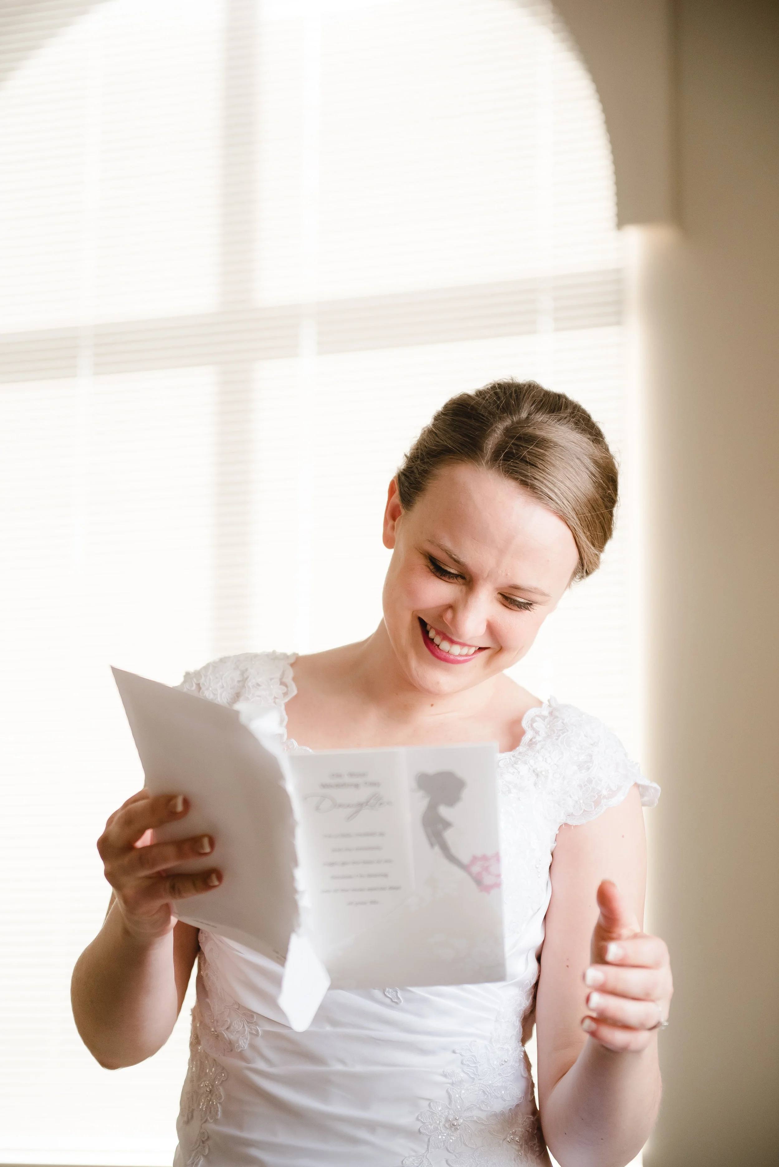 Bride reading card at St. Peter's Catholic Church - Delano, MN Wedding Photography