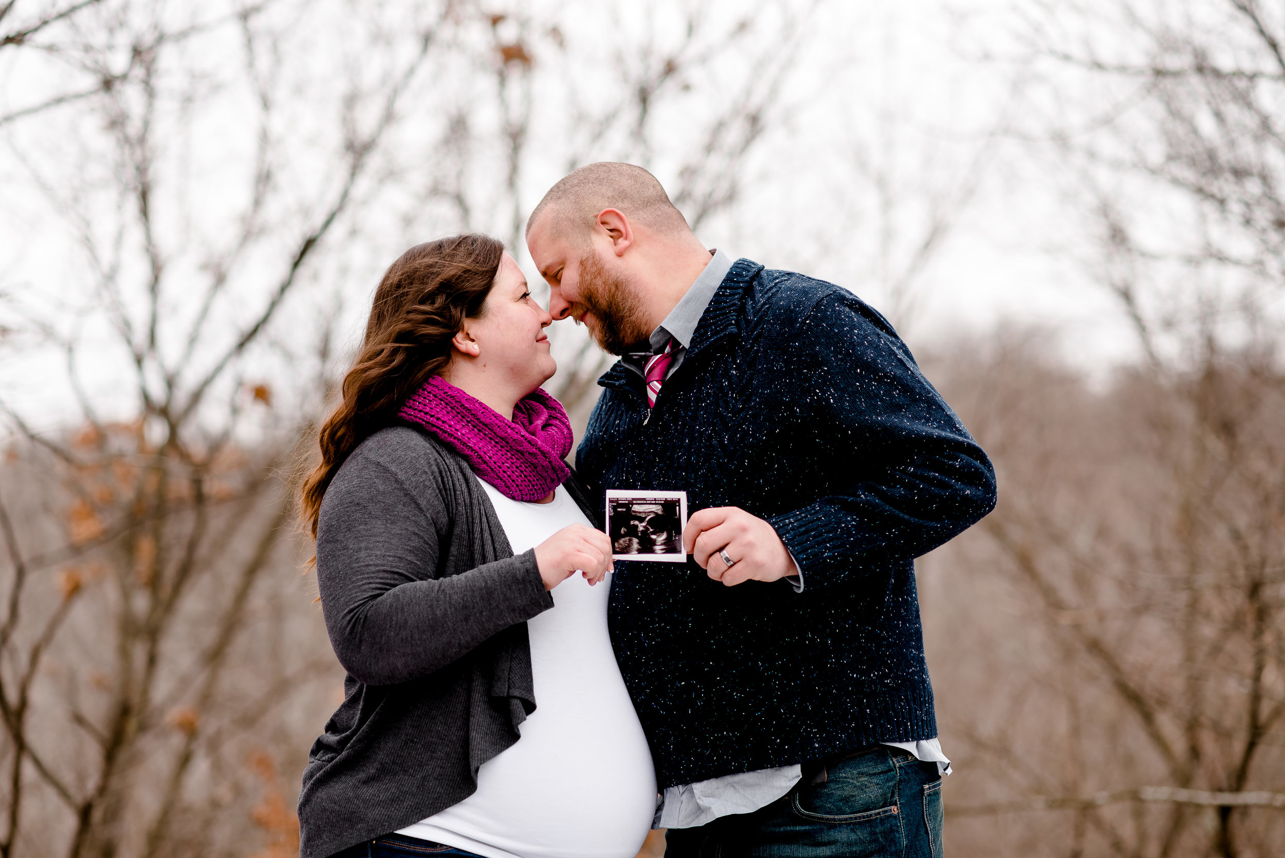 Mom and Dad with Ultrasound - Winter Maternity Photography Session at Nine Mile Creek in Bloomington MN