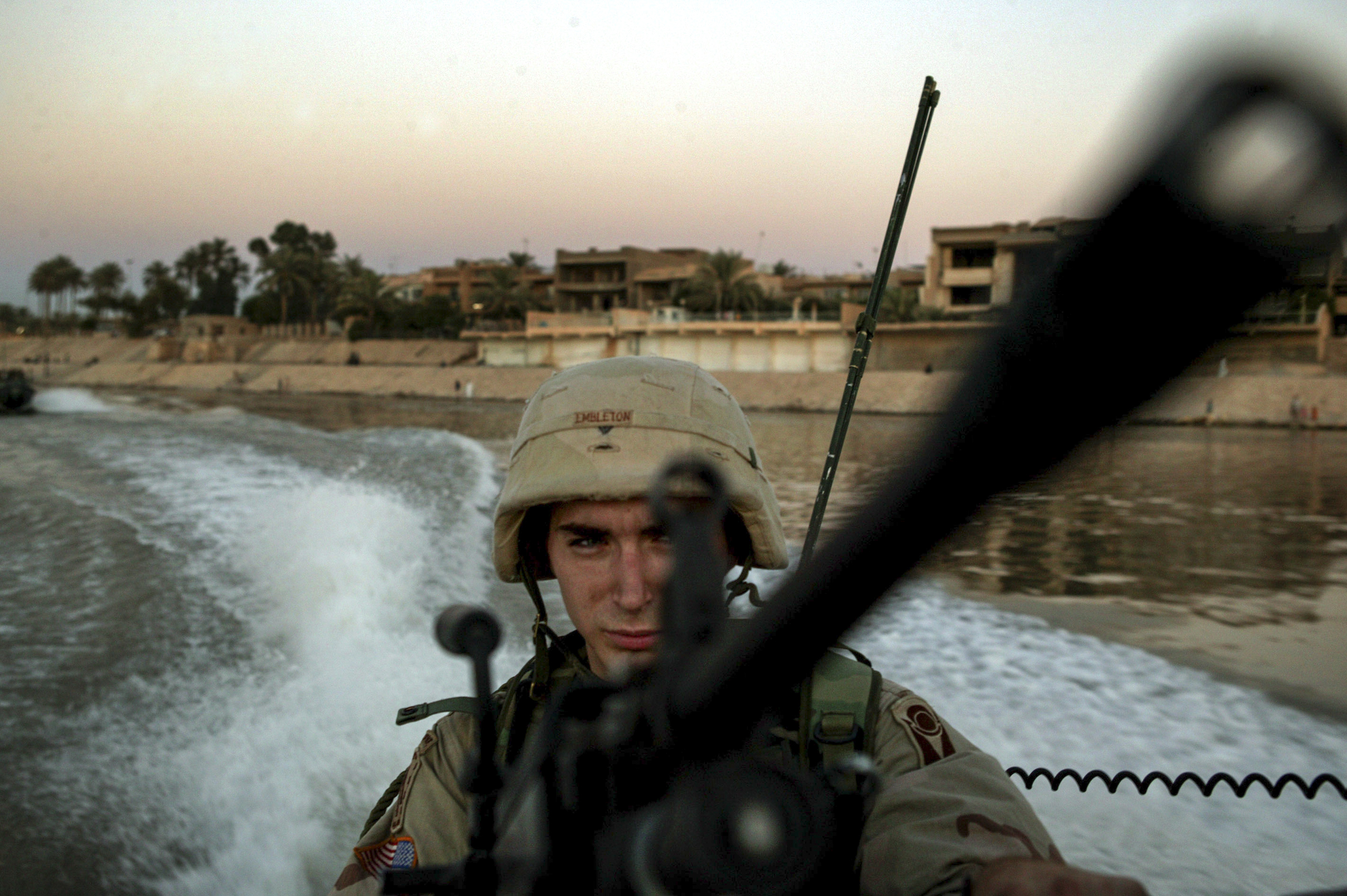  Alpha Company's David Embelton with the 3rd Battalion 124 Infantry keeps an eye on the waters during a boat patrol of the Tigris river. 