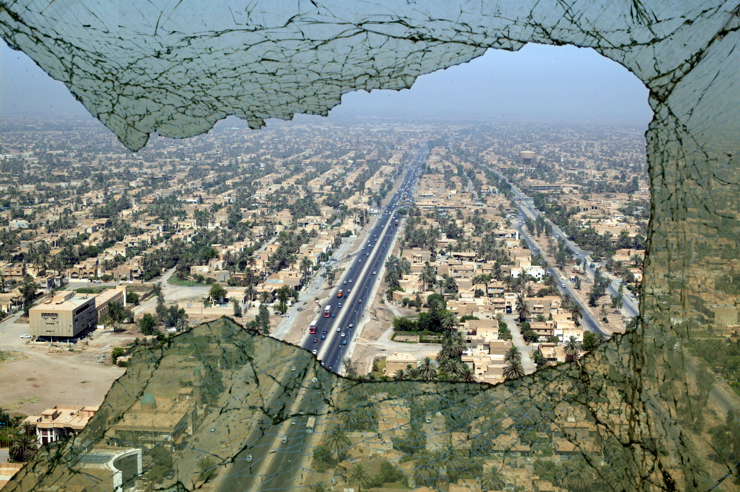  The city of Baghdad seen through the shattered window of the Tourism Tower that was bombed and looted during the war. 