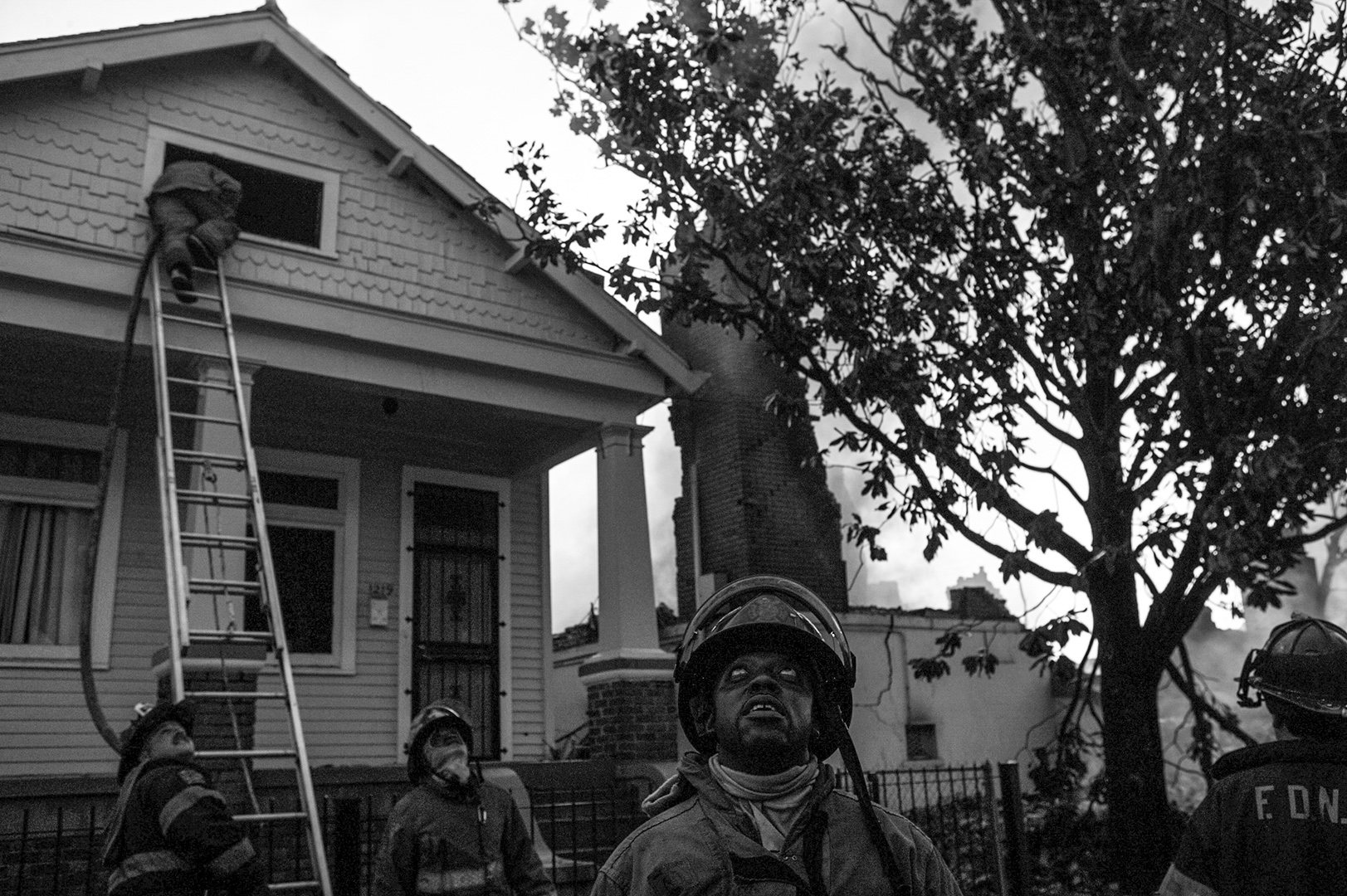  Firefighters at the scene of a house fire. 