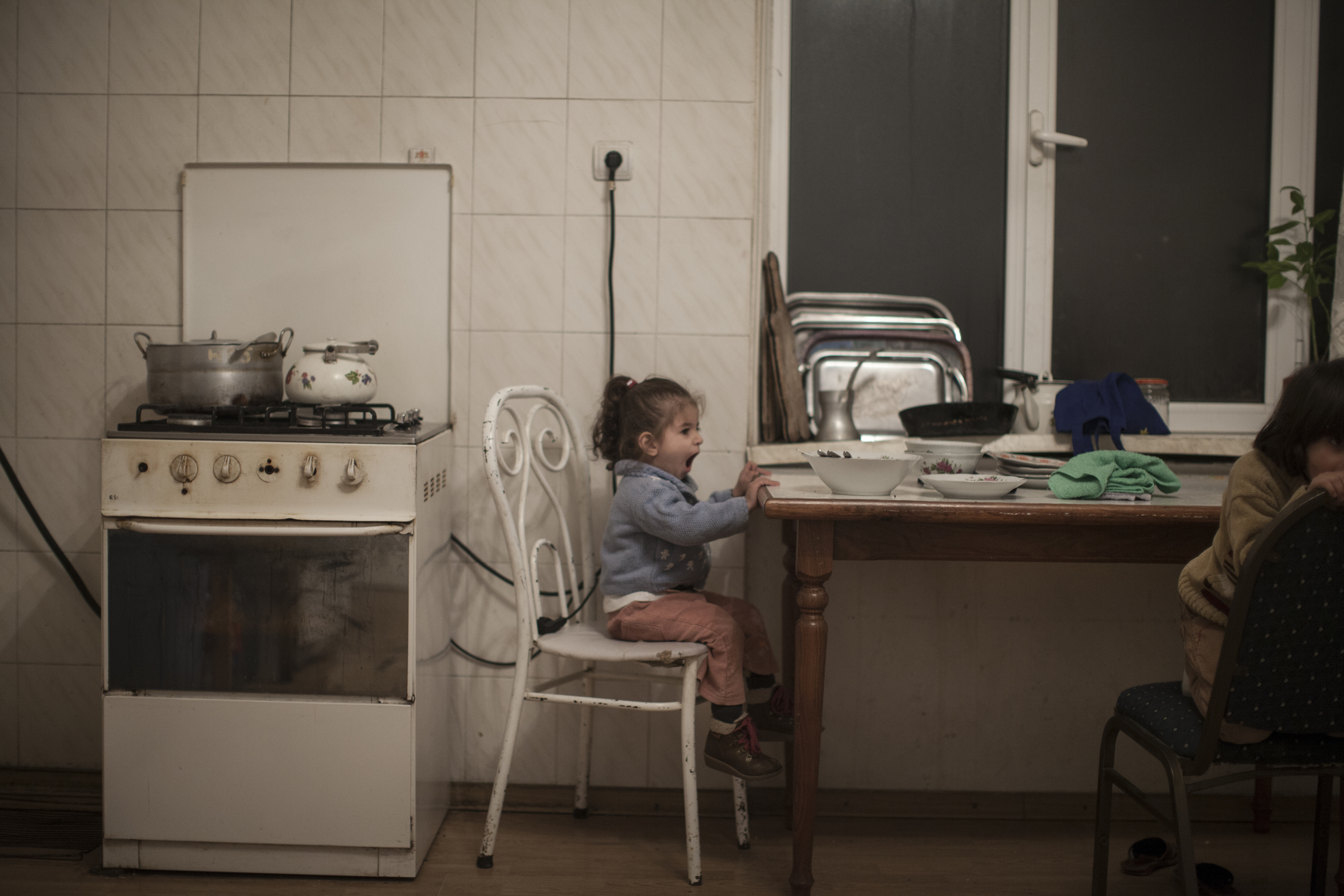  A young Syrian-Armenian girl in the kitchen of a&nbsp;building shared with a number of&nbsp;Syrian-Armenian families. 