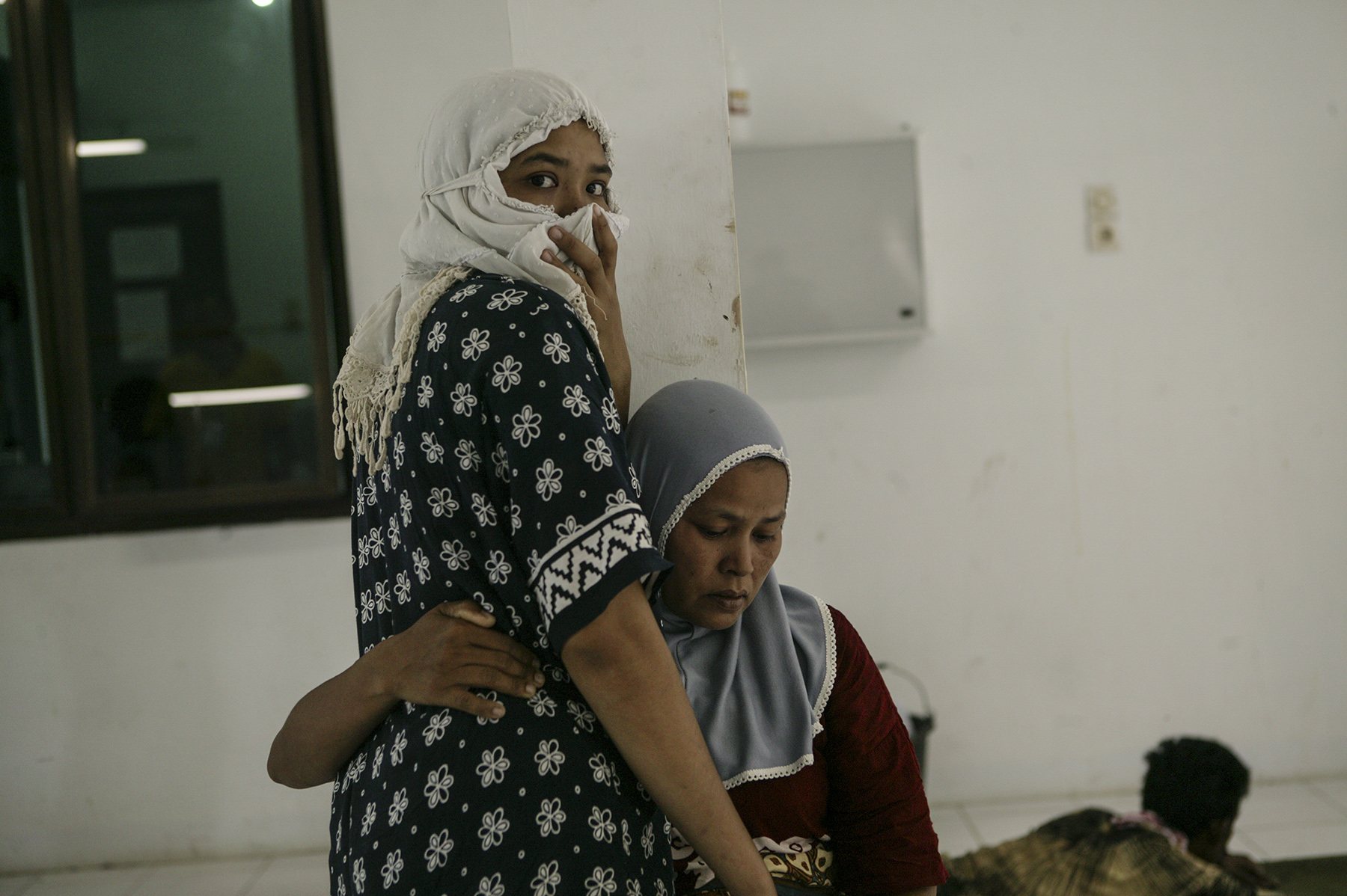  Sisters comfort each other at a hospital. 