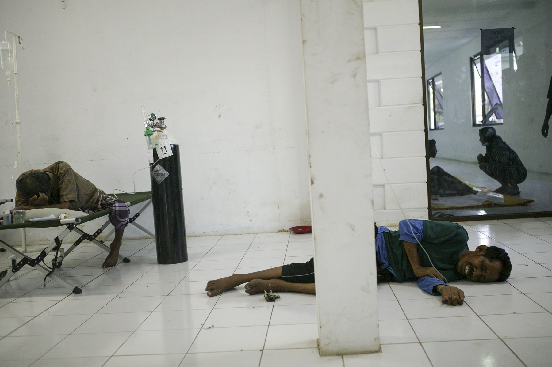  Injured survivors wait for medical attention at&nbsp;the emergency room of&nbsp;a hospital in Banda Aceh. 