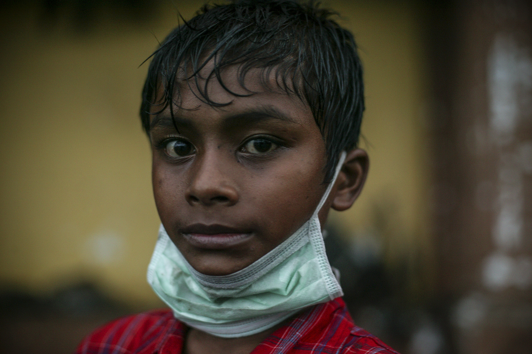  A young boy salvages found items in the muddy and debris filled streets of Banda Aceh. 